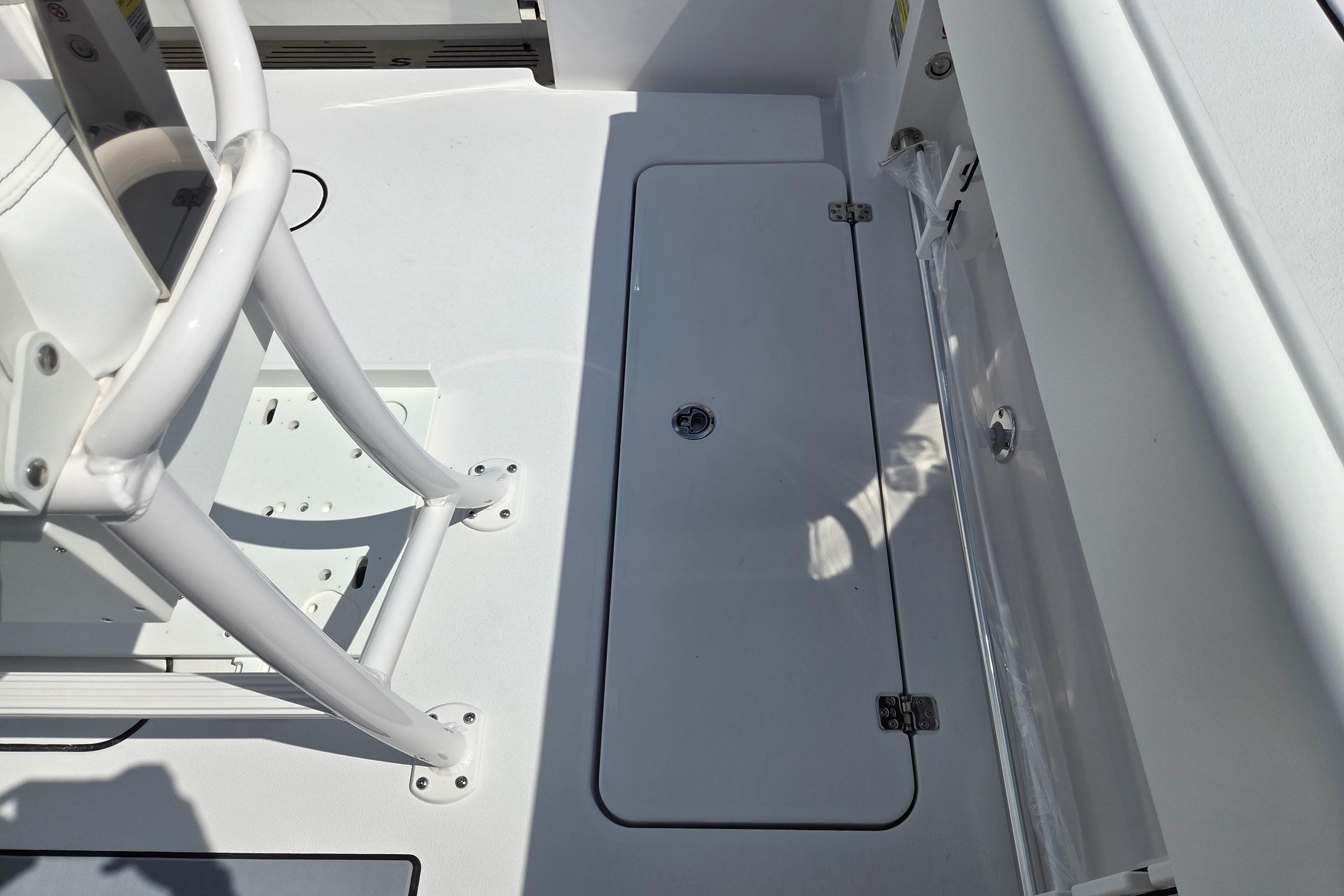 2026 Sportsman Open 252 Center Console boat deck with storage hatch and seating.