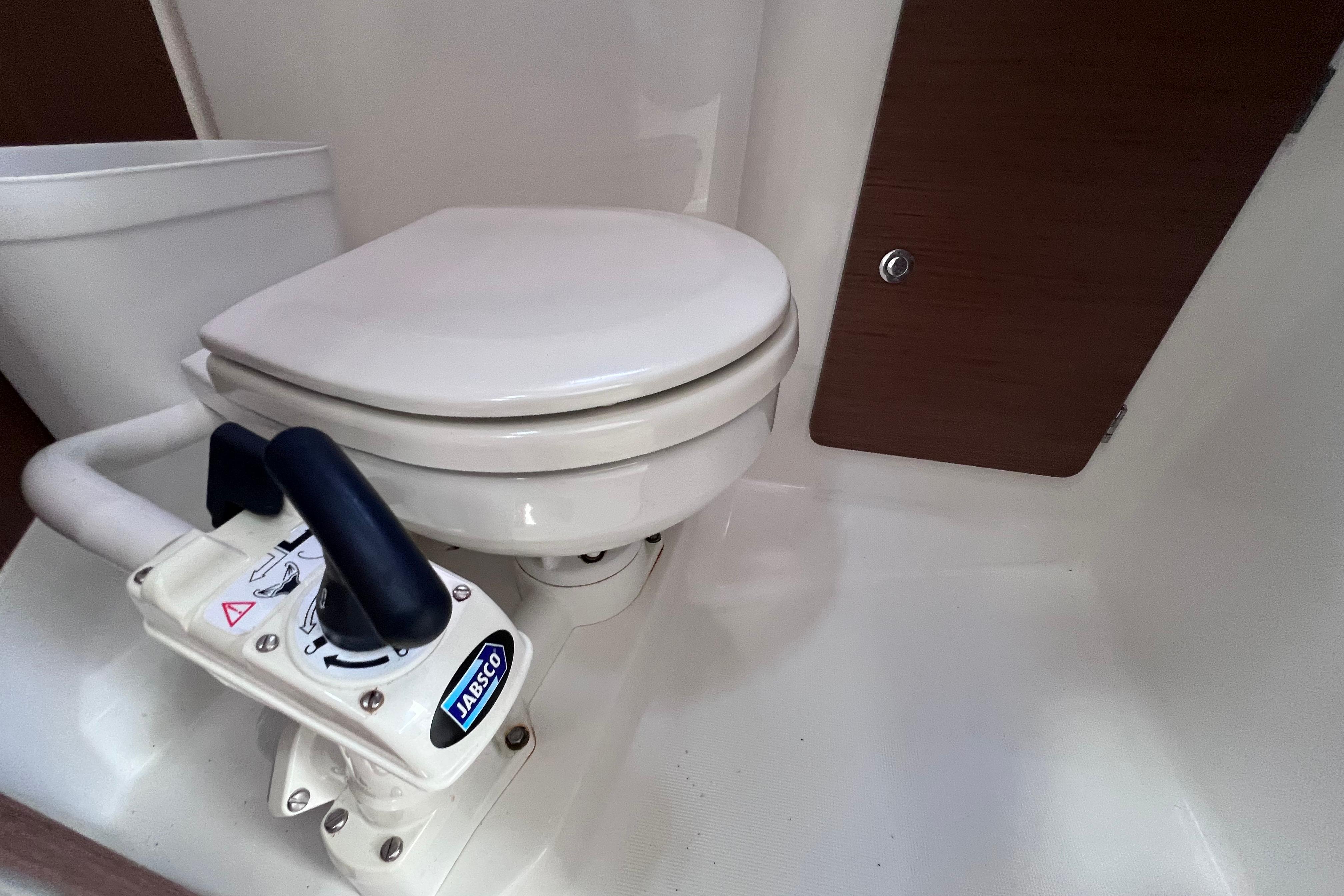Toilet in Jeanneau NC Weekender 795 Series 2 boat, 2021 model, featuring Jabsco manual pump.