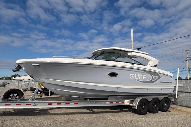 2024 Chaparral 30 Surf boat on trailer under blue sky.