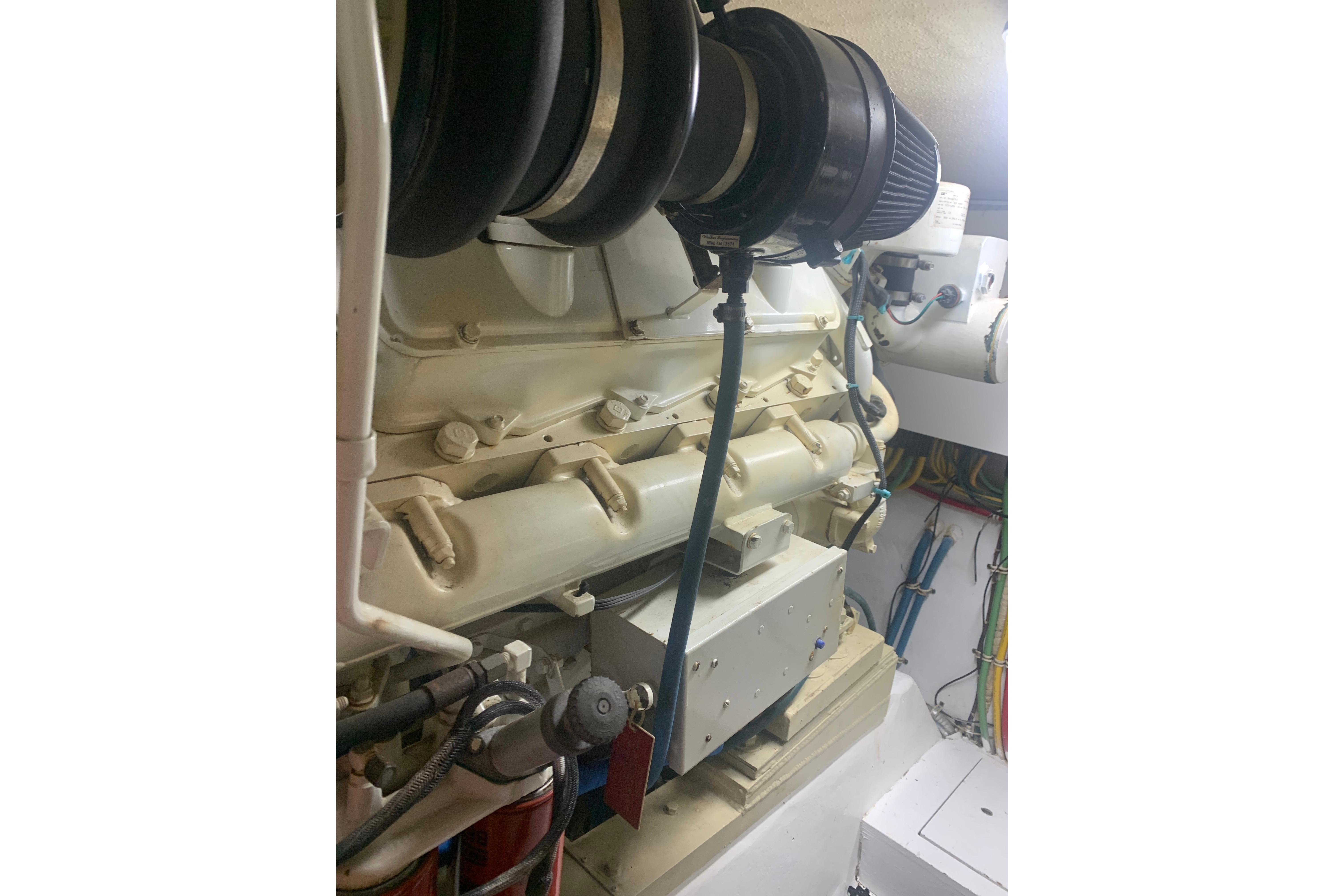 Engine room of 1999 Hatteras 52 Cockpit Motor Yacht with visible components and wiring.