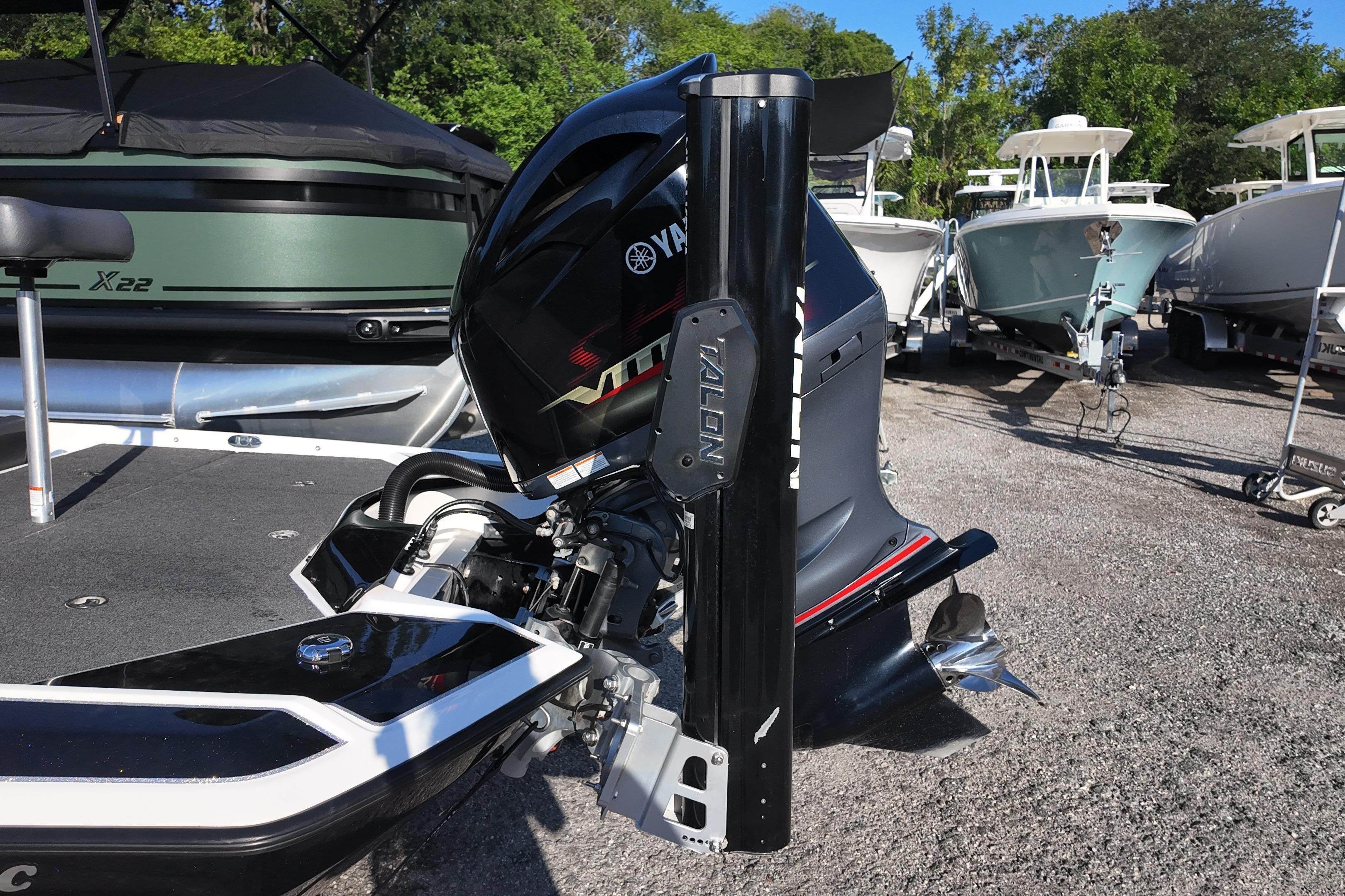 Outboard motor on a 2022 Bullet 21SDC boat, parked among other boats.