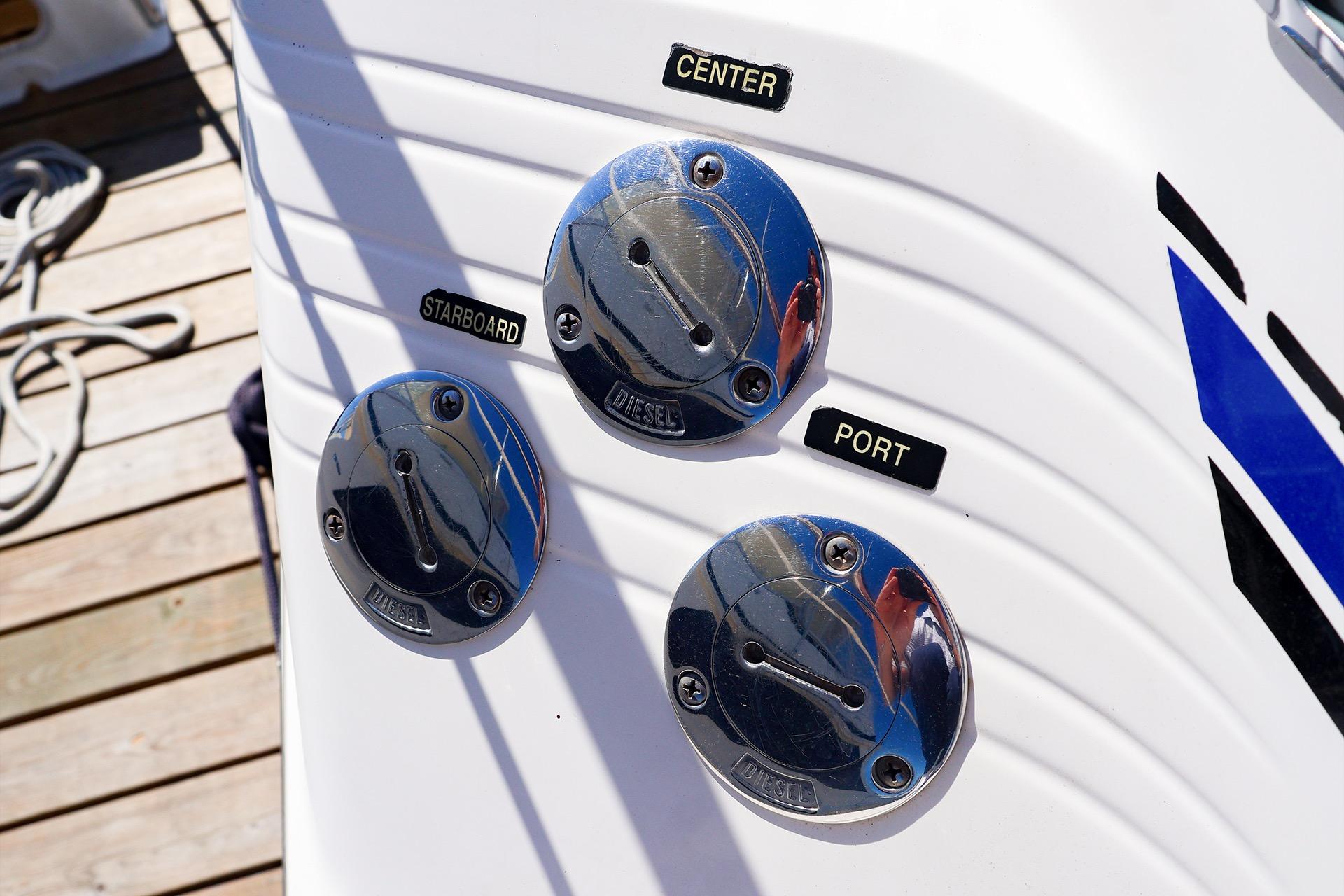 Fuel caps on a 1998 Sea Ray 500 Sundancer boat, labeled center, starboard, and port.