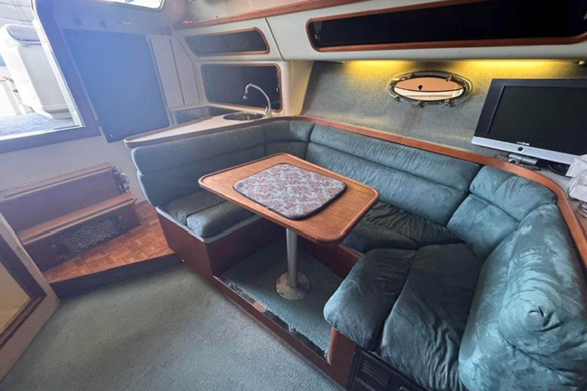 1988 Tiara Yachts 3300 Open interior with cozy seating and compact dining area.