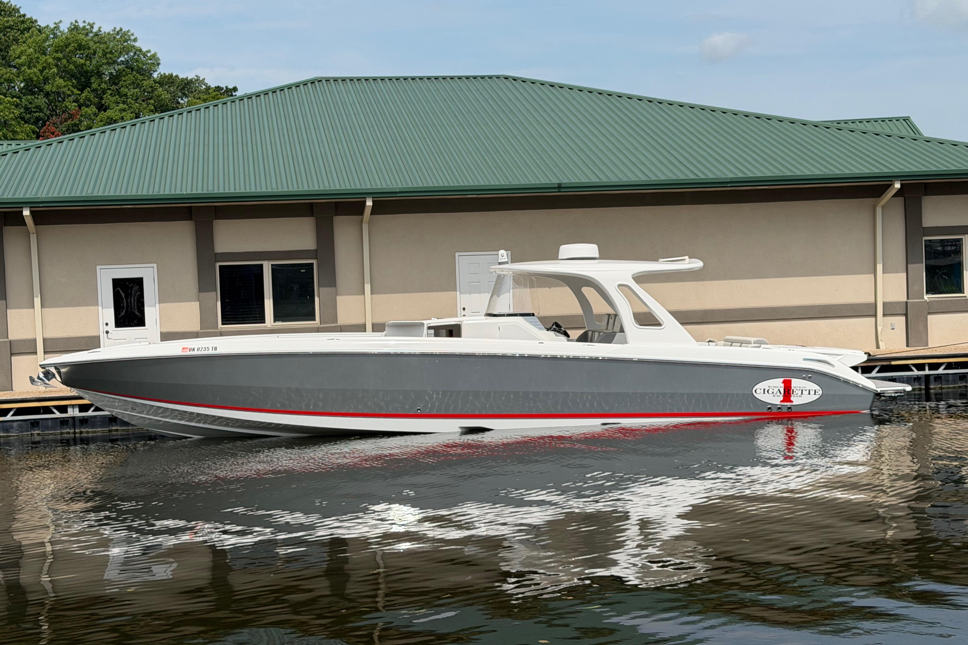 2015 Cigarette 41' Nighthawk SD Edition boat docked by a building.