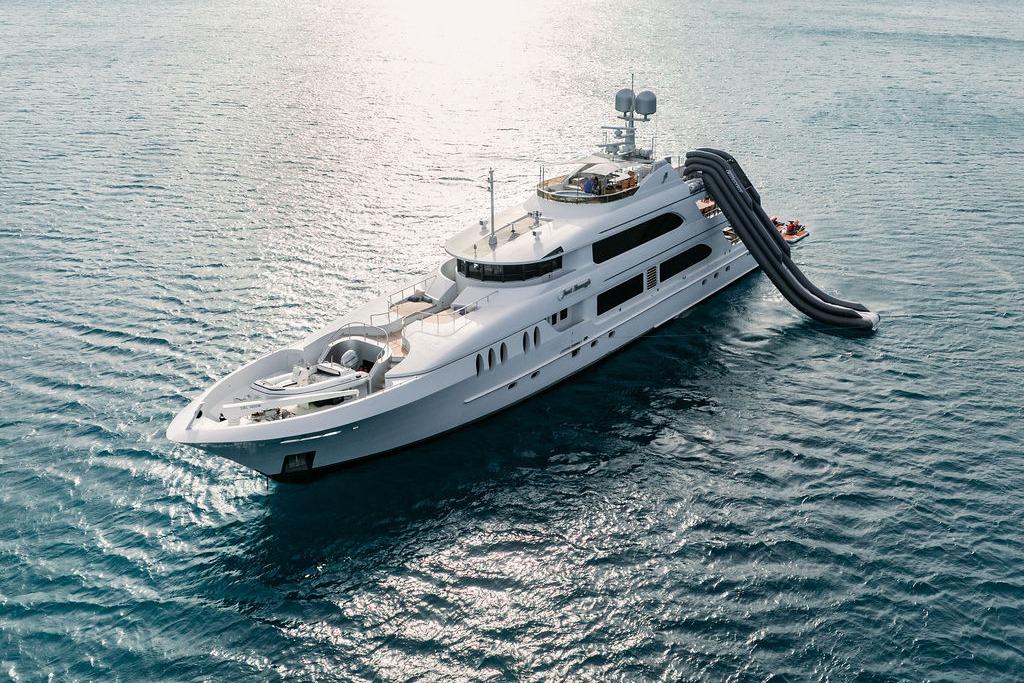 Luxurious 2012 Ares Custom Marine 141 yacht with slide on open sea.