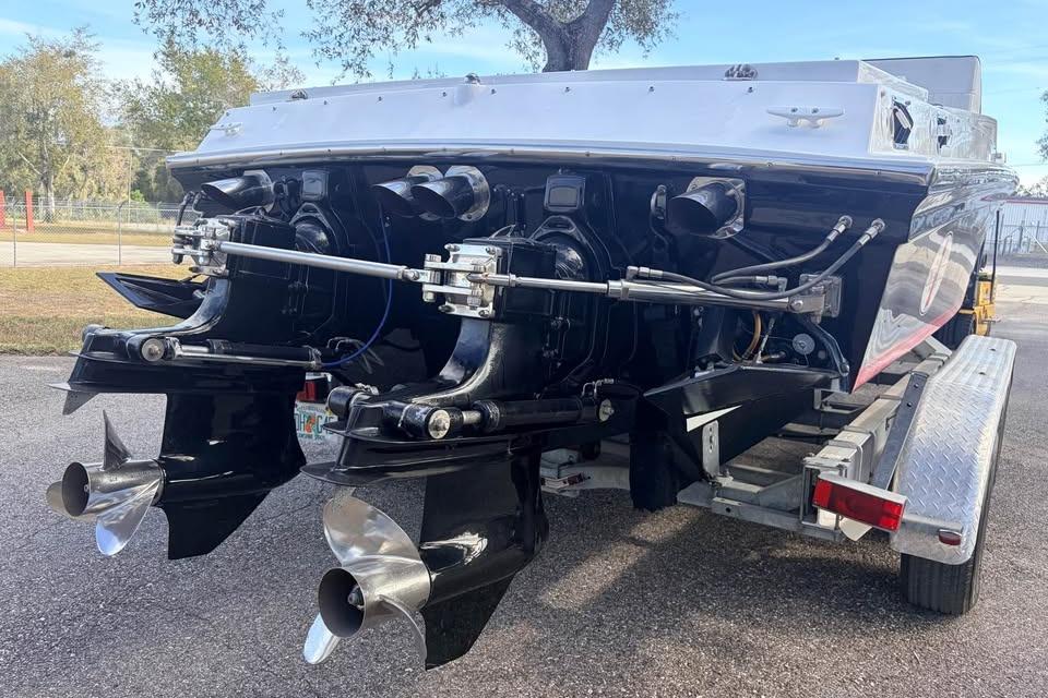 1983 Cigarette 24' Classic boat on trailer, showcasing dual propellers and sleek design.