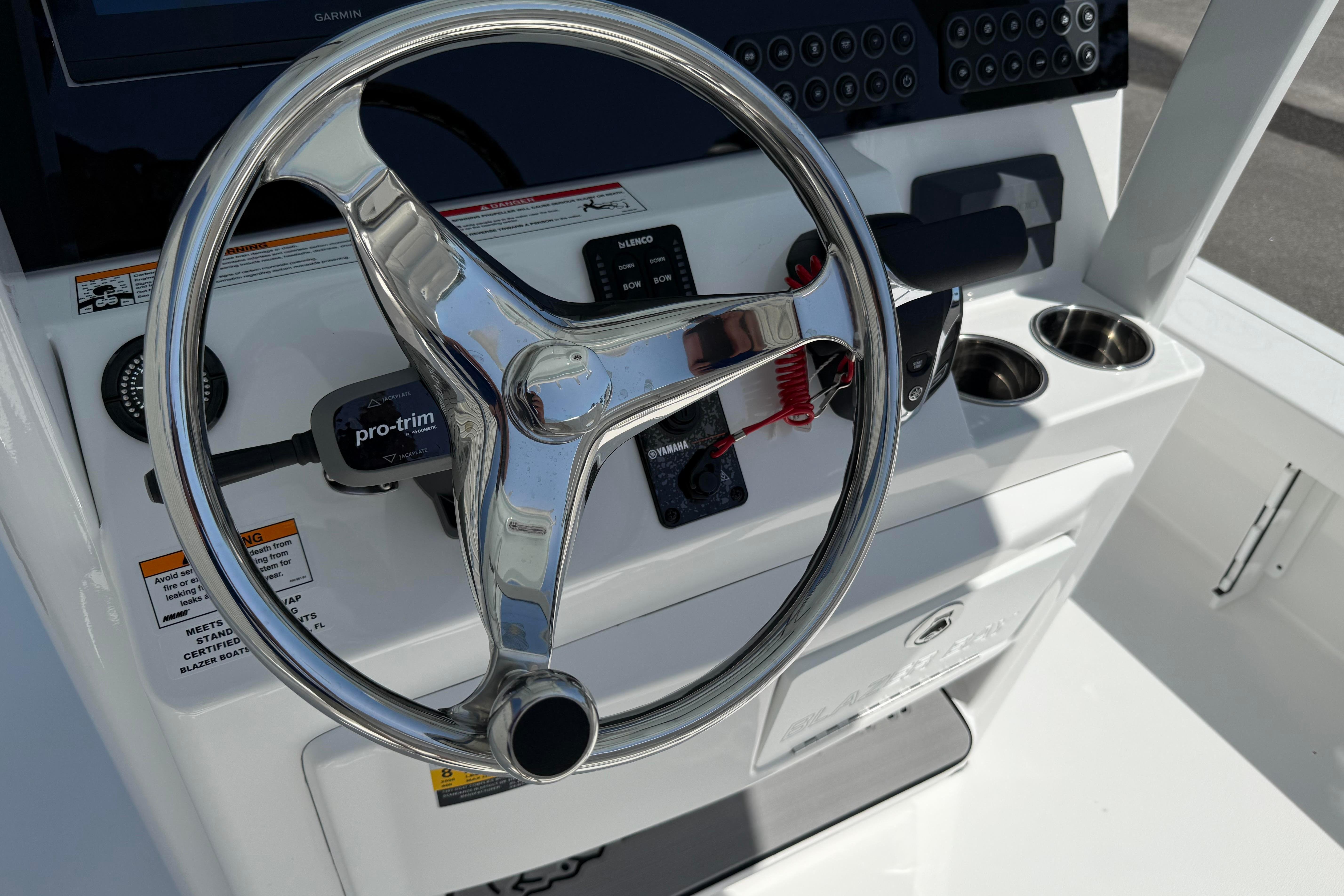 2026 Blazer 2550 GTS boat steering console with modern controls and cup holders.