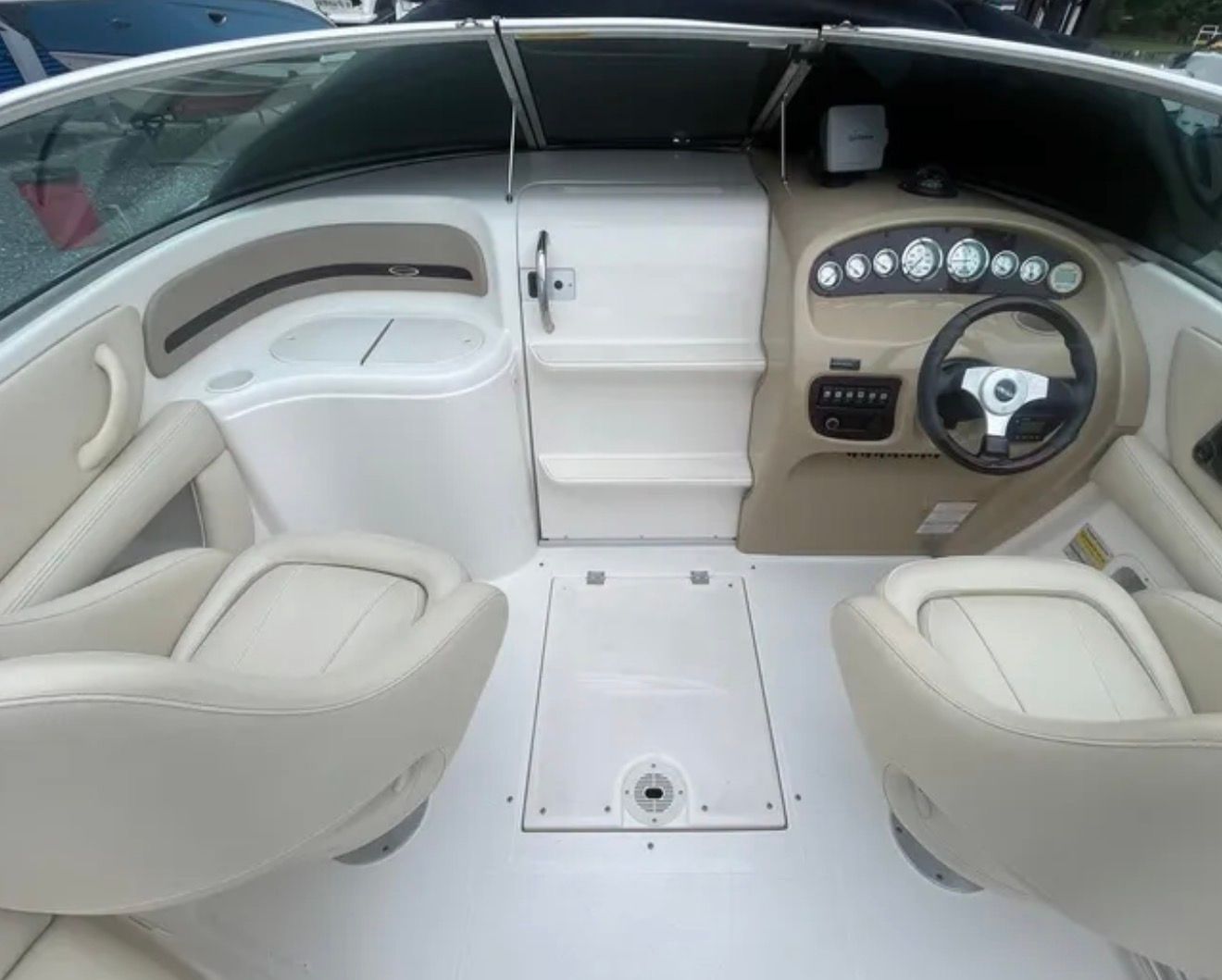 The image shows the cockpit of a 2007 Chaparral 235 SSi boat with two seats and a helm.