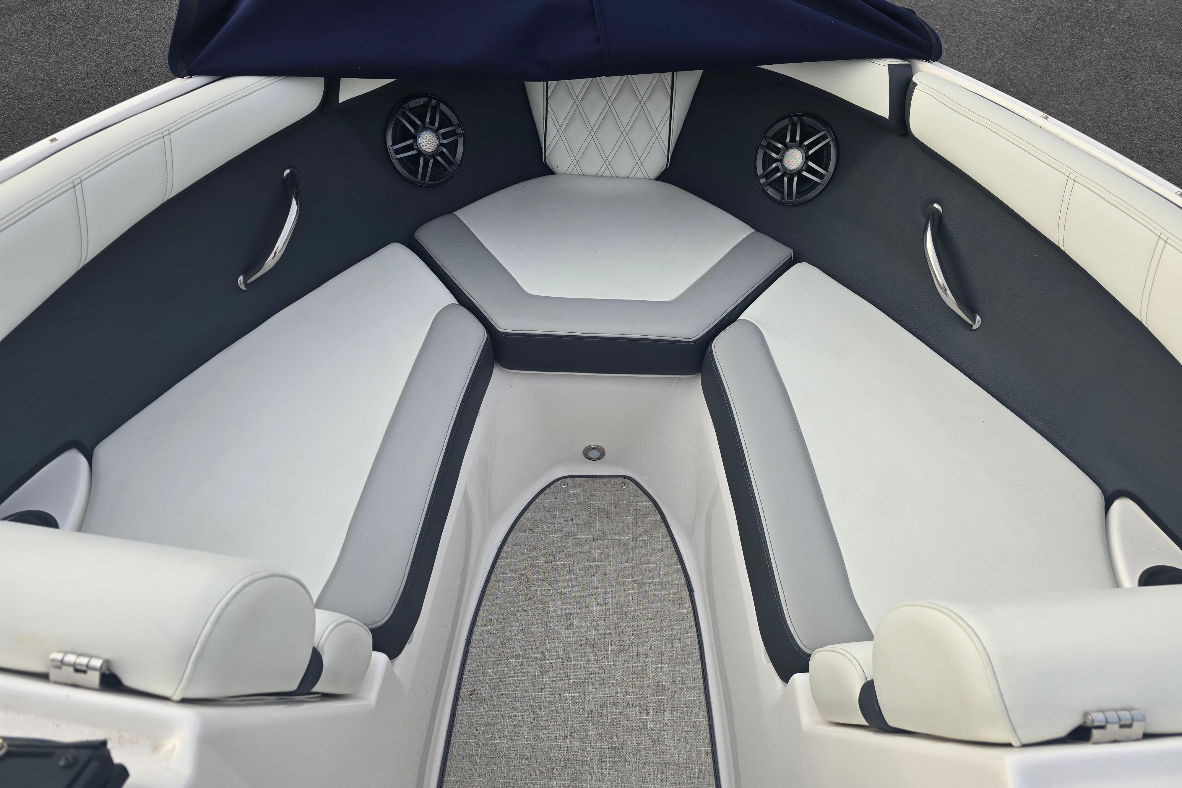Interior of 2022 Regal 2000 ES boat with cushioned seating and speakers.