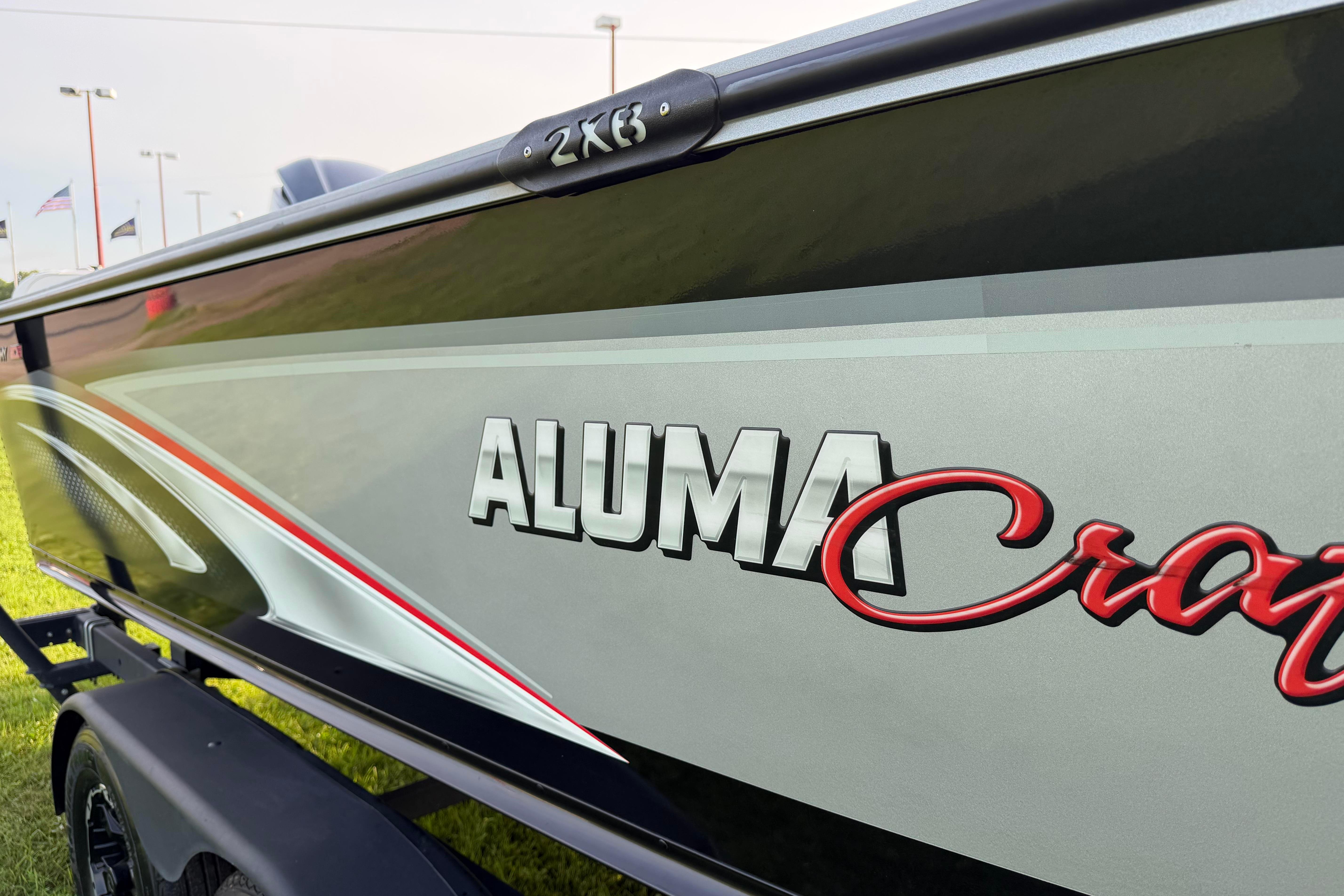 2019 Alumacraft Trophy 205 boat side view with logo and sleek design.