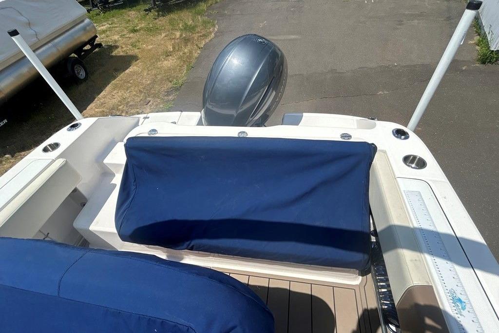 2017 Robalo R200ES boat interior with blue seat covers and outboard motor.