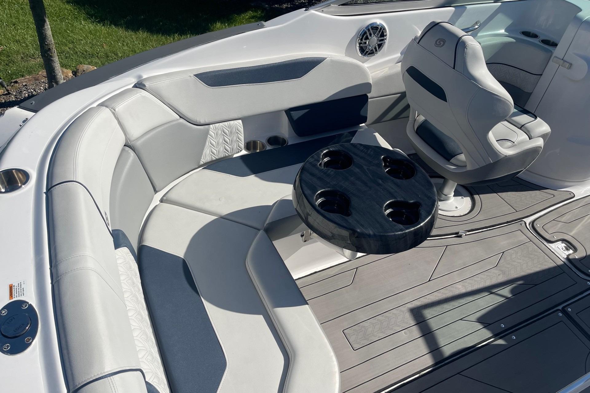 2023 Hurricane SunDeck 2400 OB boat interior with seating and cup holders.