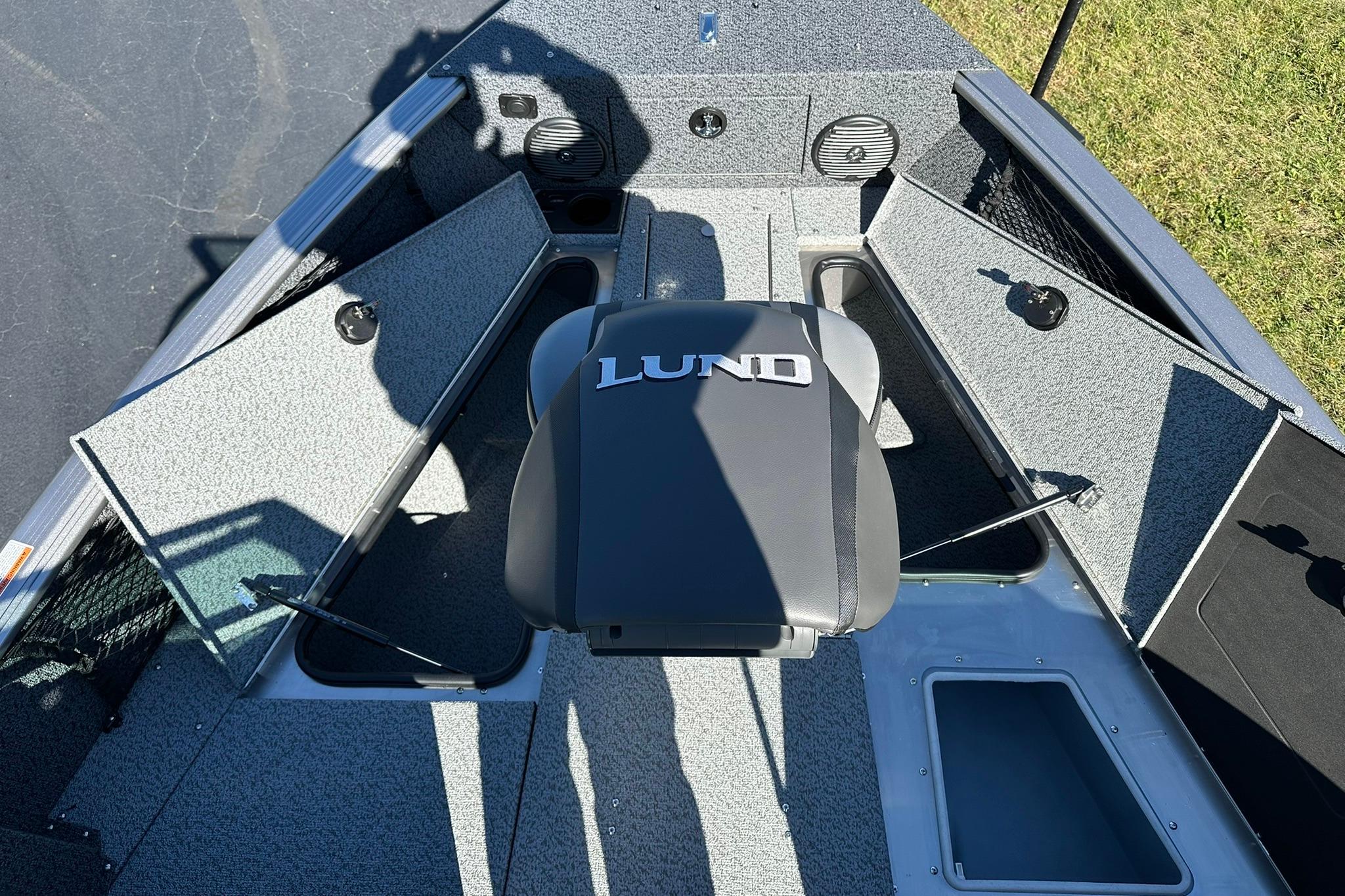 2026 Lund 1875 Impact XS Sport boat interior with open storage compartments and seating.