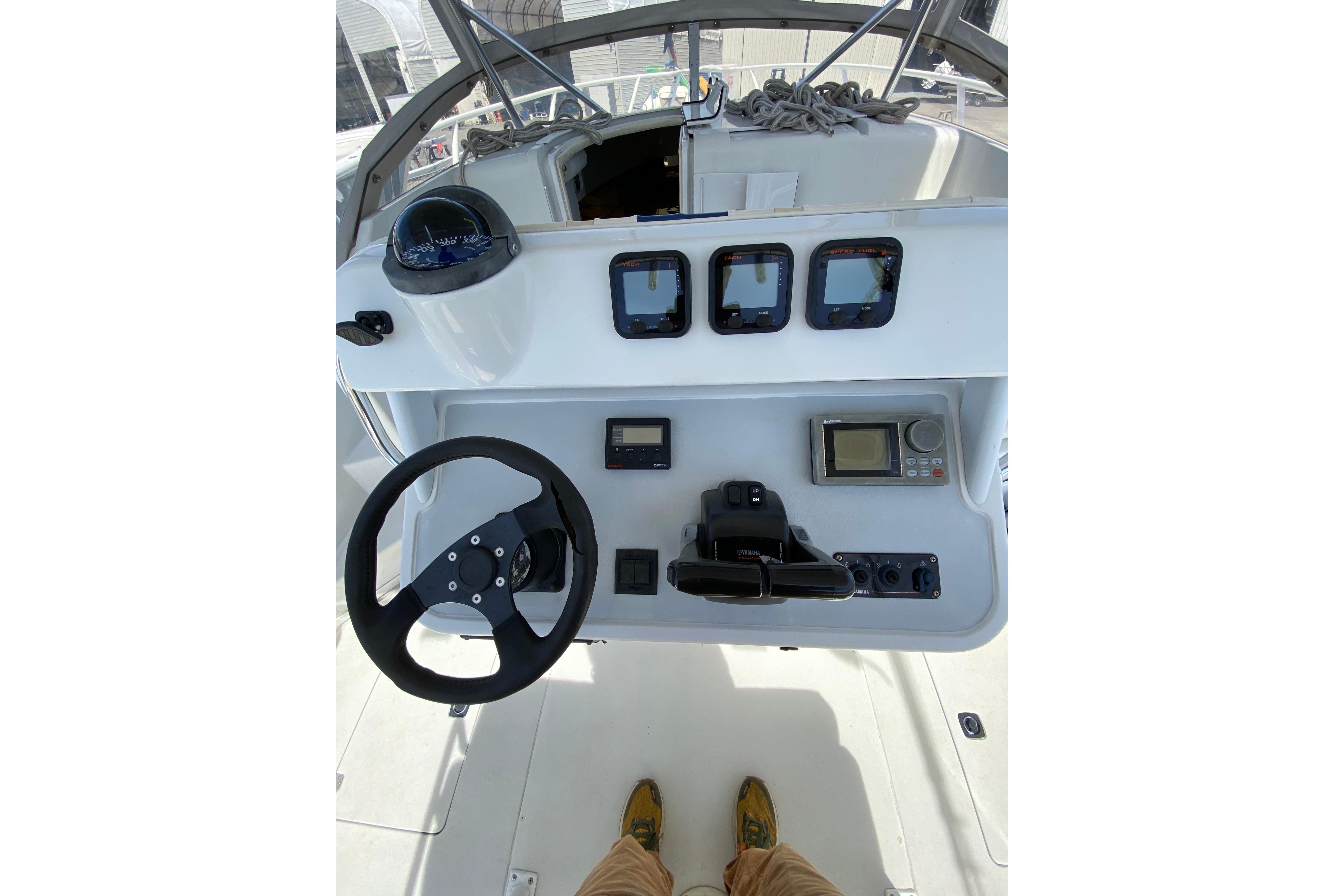 1996 Intrepid 337 boat dashboard with steering wheel and navigation instruments.