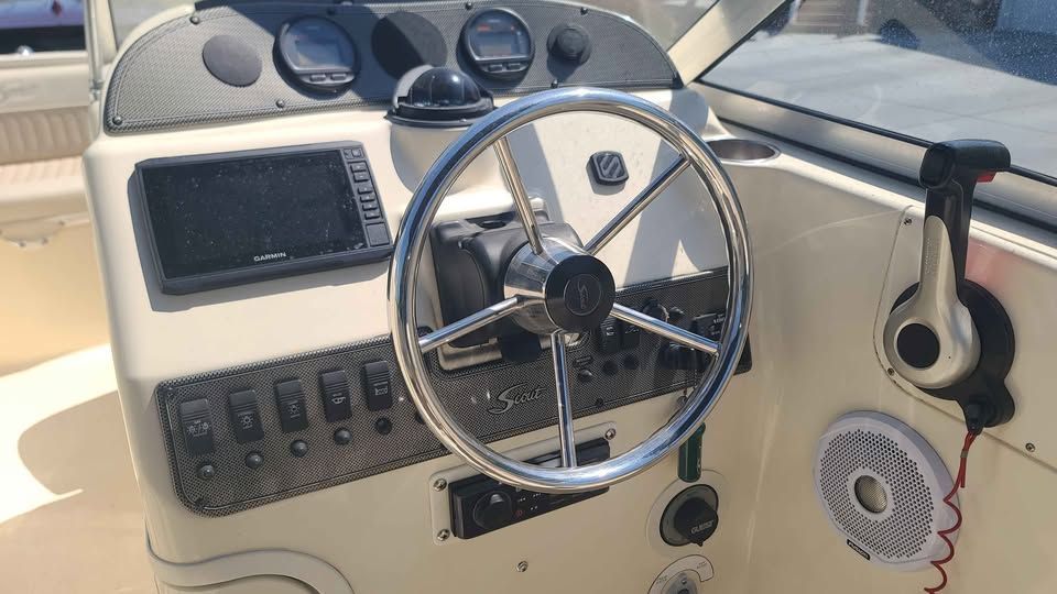 The image shows the helm of a 2005 Scout 222 Dorado boat with instruments and controls.