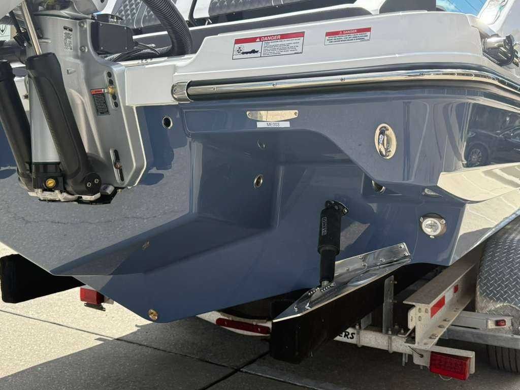 The image shows the stern of a Monterey Elite 30 OB boat on a trailer.