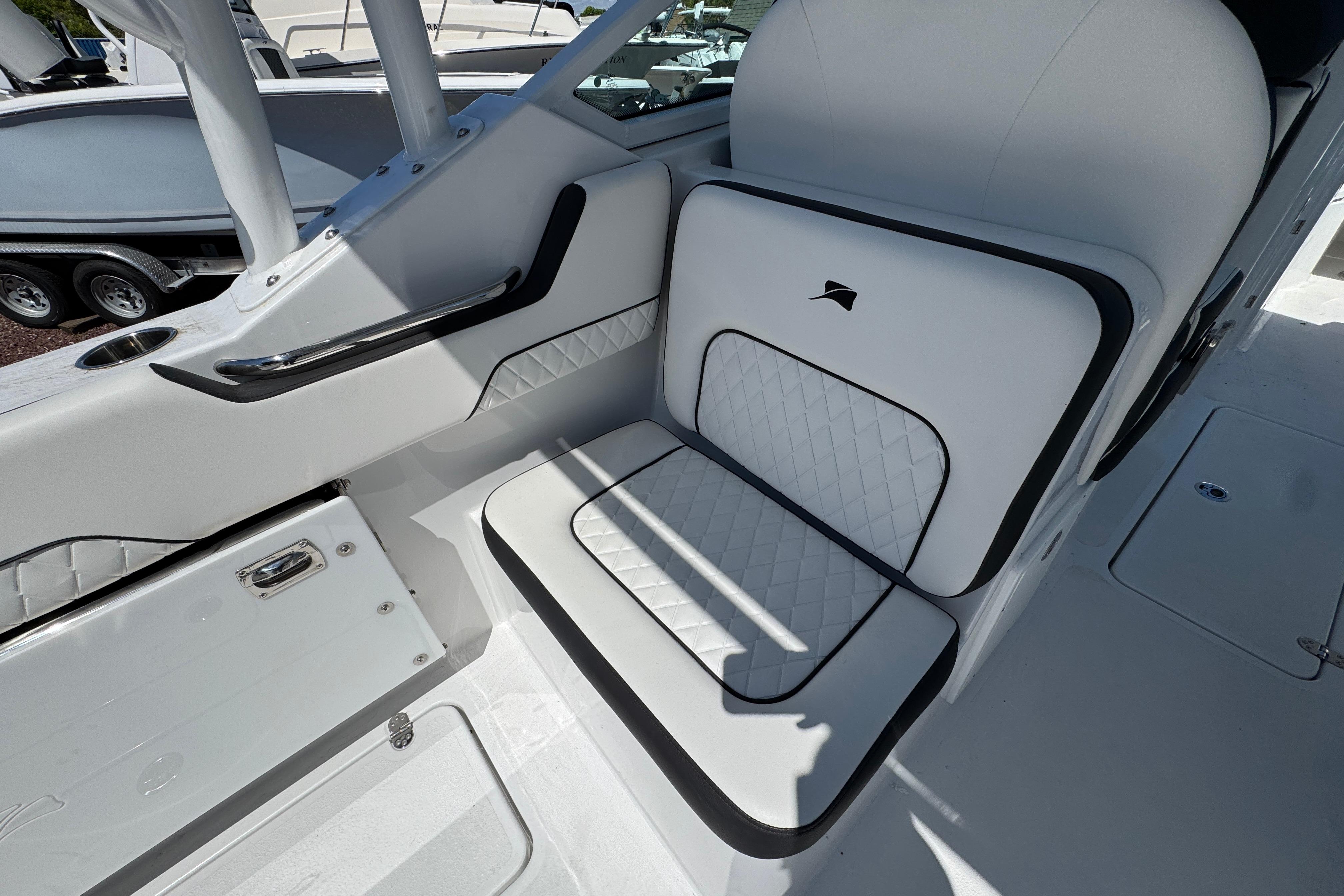 2026 Stingray 259 DC boat interior with white cushioned seating and sleek design.