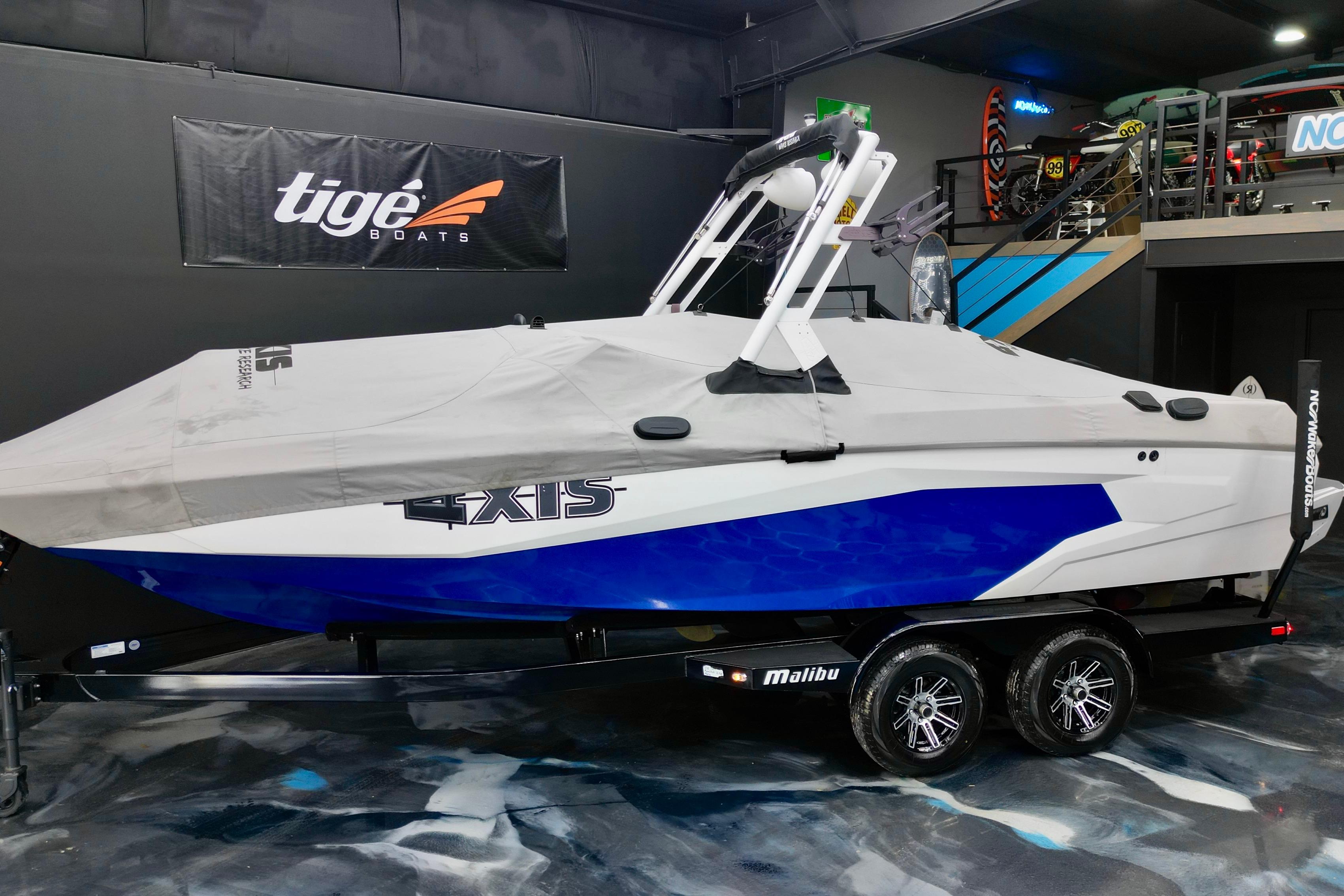 2023 Axis A225 boat with cover on trailer in showroom.