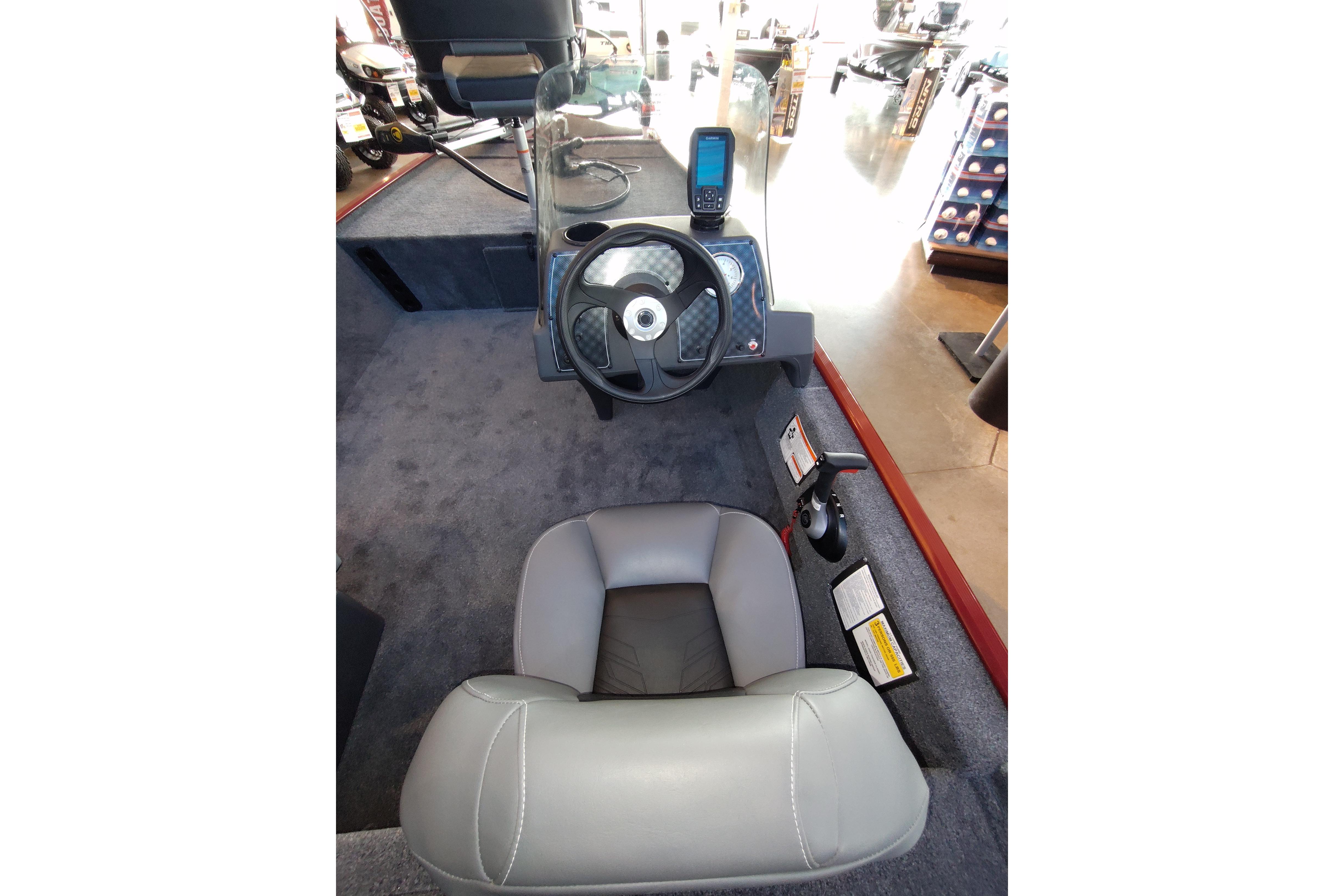 Interior view of 2026 Tracker Bass Tracker Classic XL boat cockpit with steering wheel and seat.