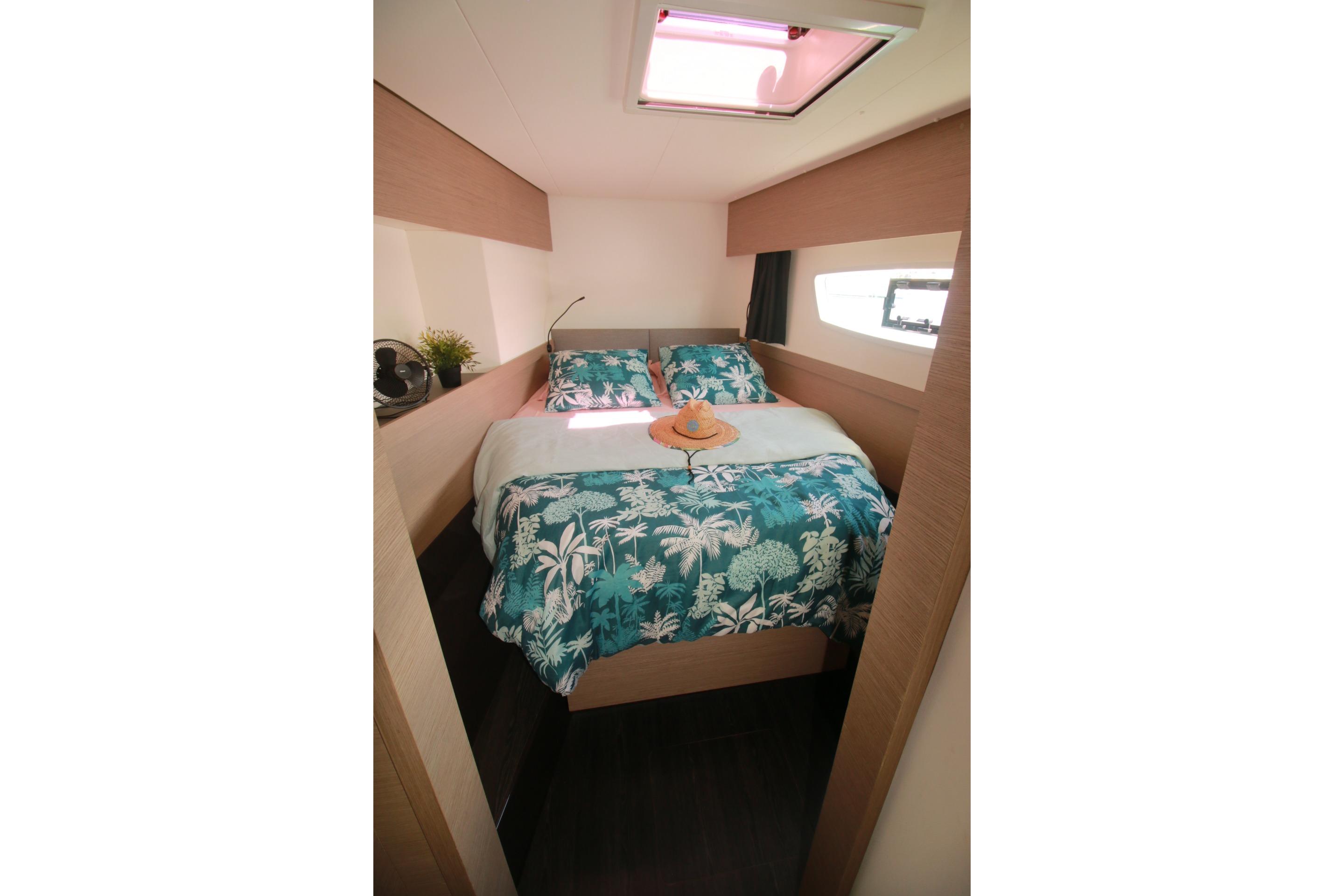 2022 Fountaine Pajot Elba 45 Catamaran cabin with tropical-themed bedding and skylight.
