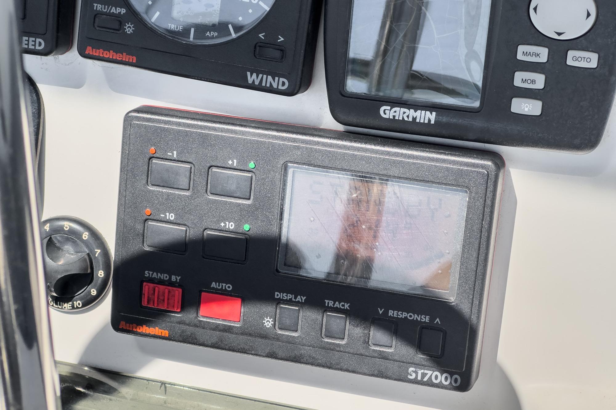 Control panel of a 1996 Hunter 376 sailboat featuring Autohelm and Garmin devices.