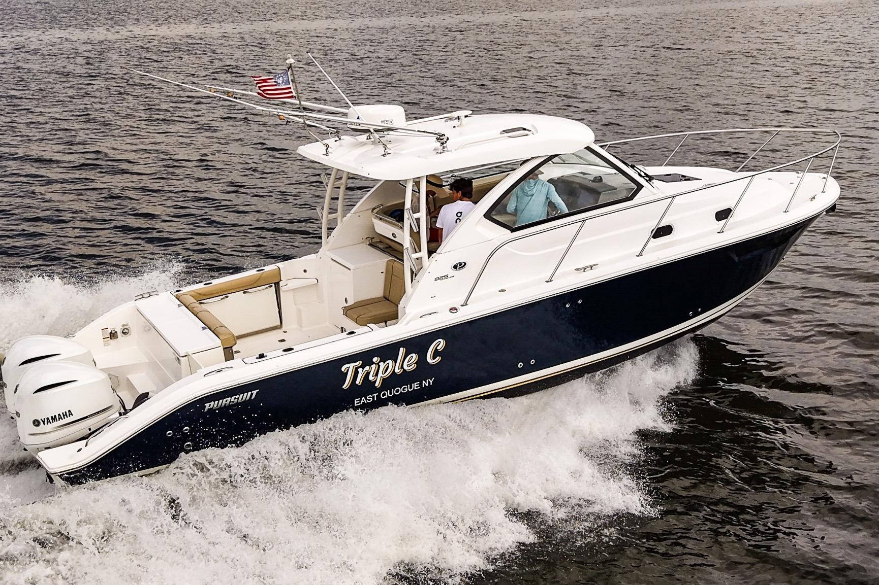 2020 Pursuit OS 325 Offshore boat cruising on water with American flag.