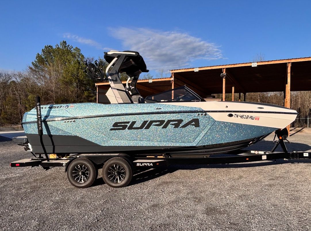 2025 Supra SA 450 boat on trailer, side view.