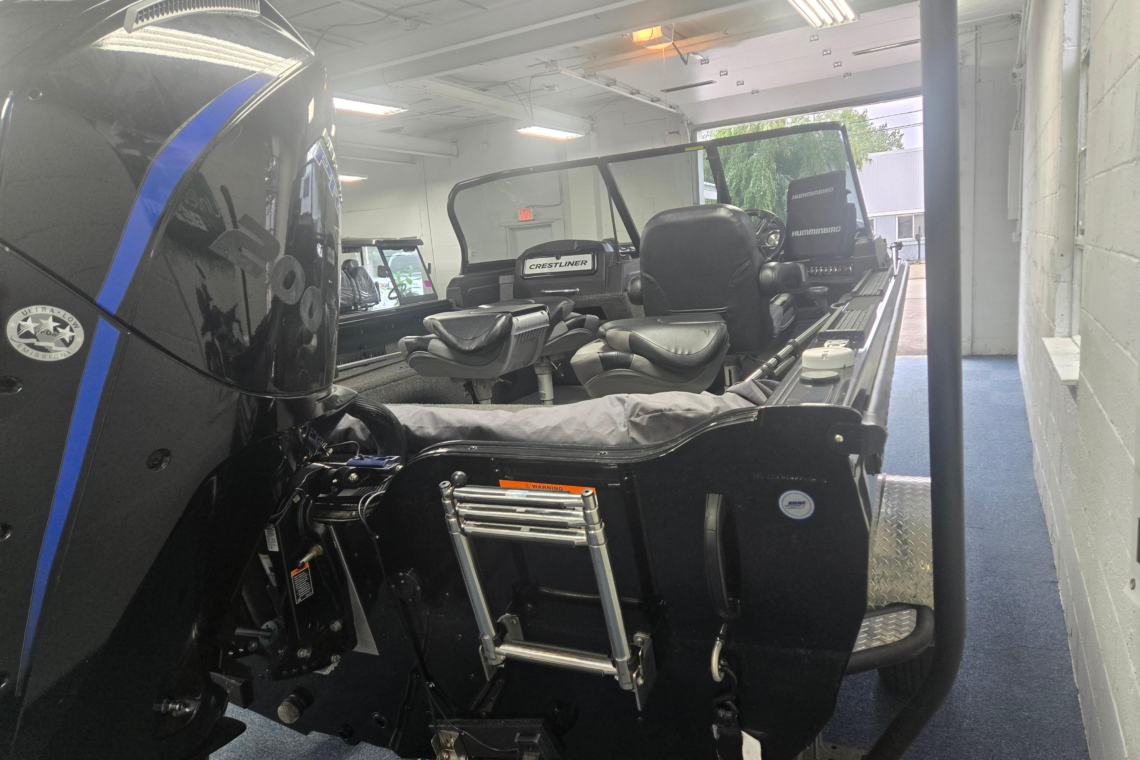 2020 Crestliner 1850 Raptor WT boat interior with seating and motor in showroom.