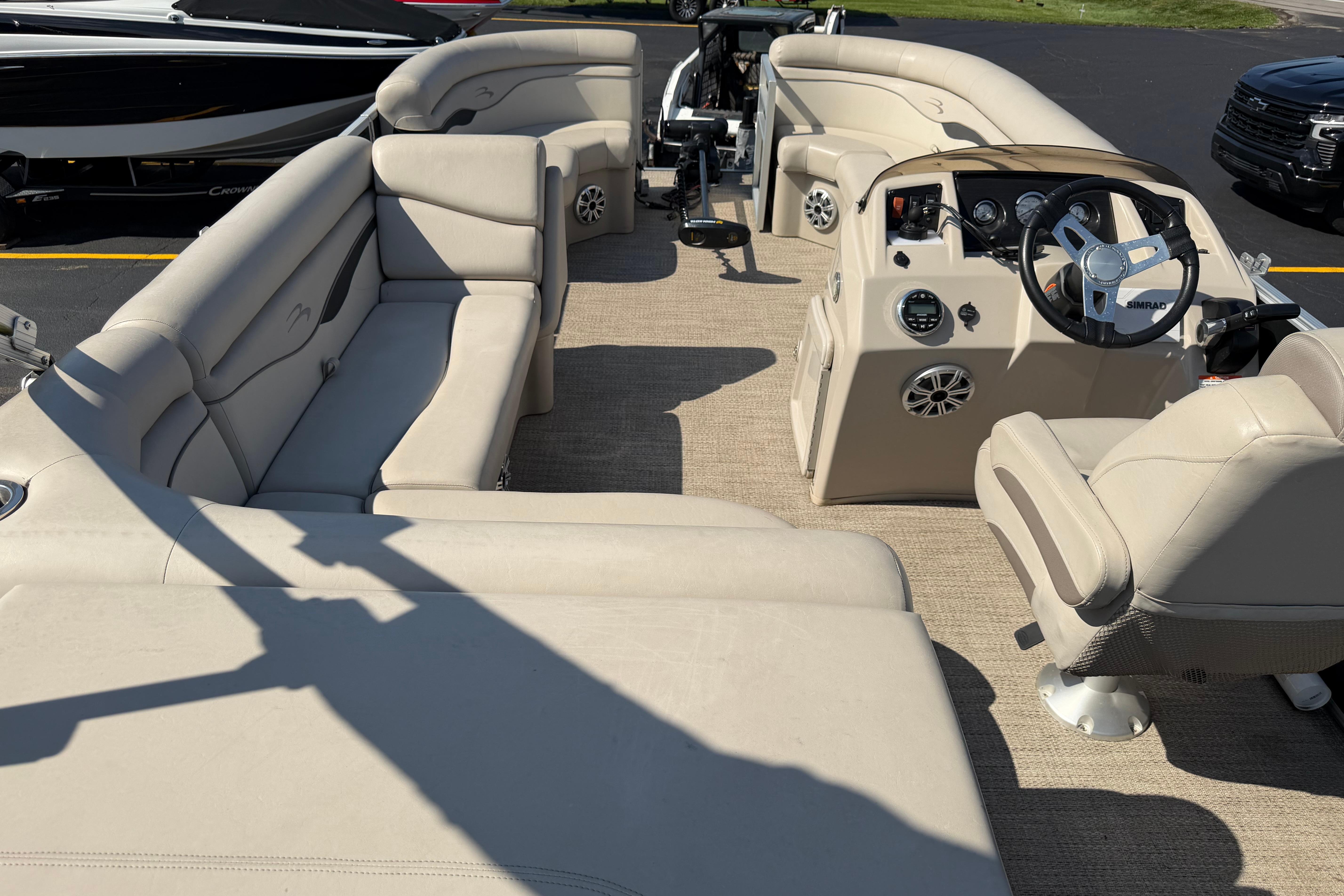 2018 Bennington 21 SF boat interior with beige seating and steering console.