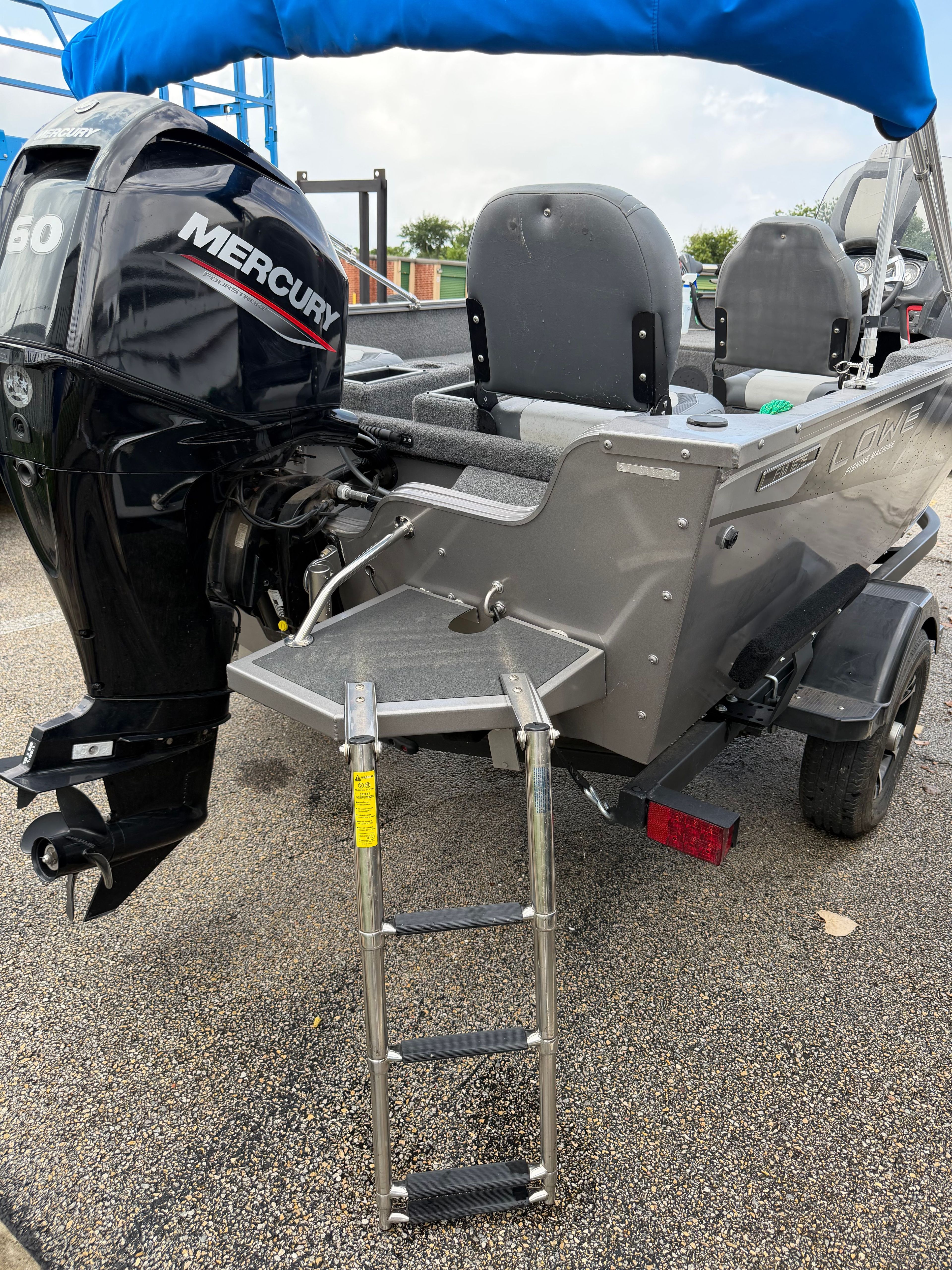 The image shows a gray Lowe Fishing Machine 1675SC boat with a Mercury outboard motor.