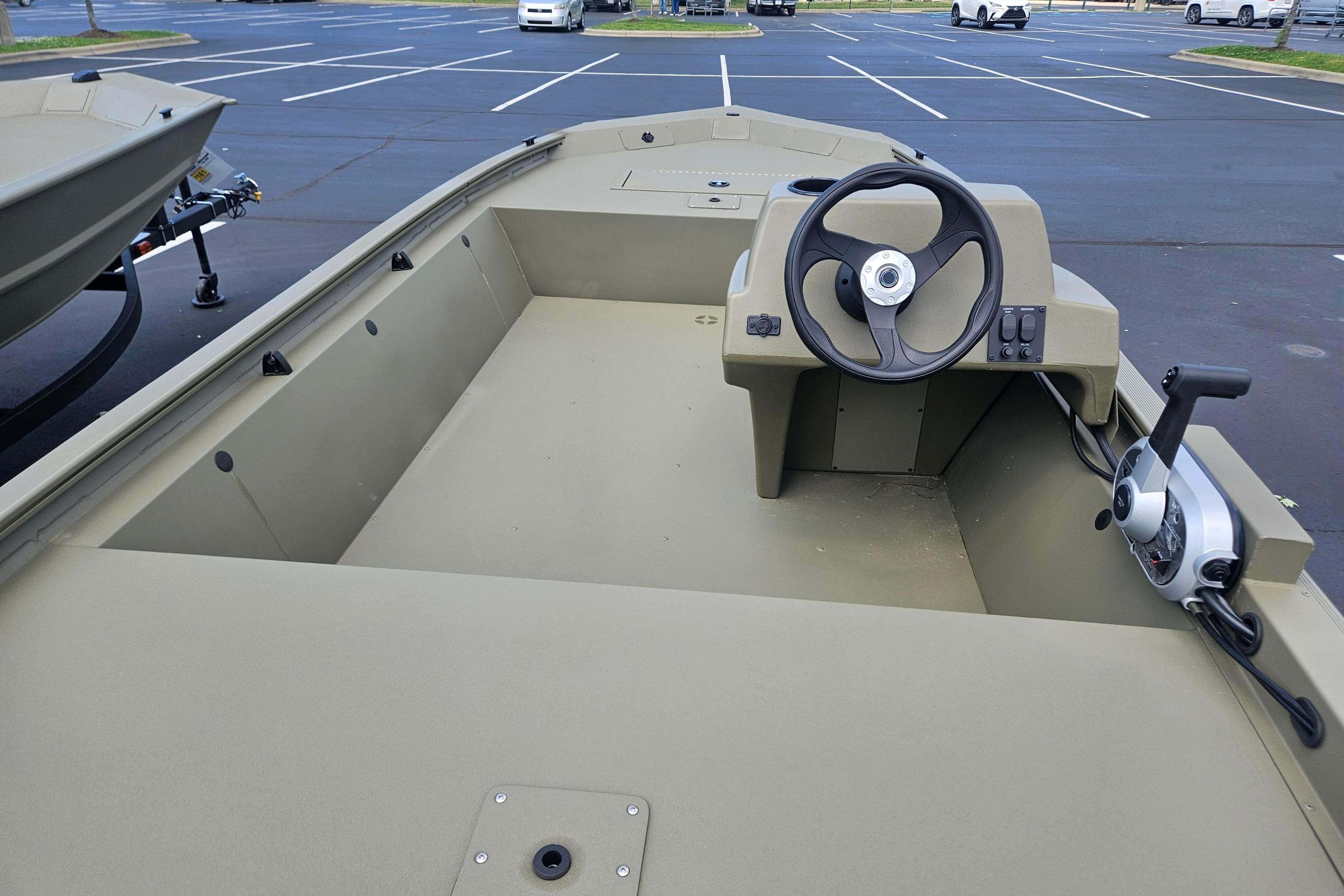 2026 Tracker Grizzly 1648 SC boat interior with steering wheel and control panel.