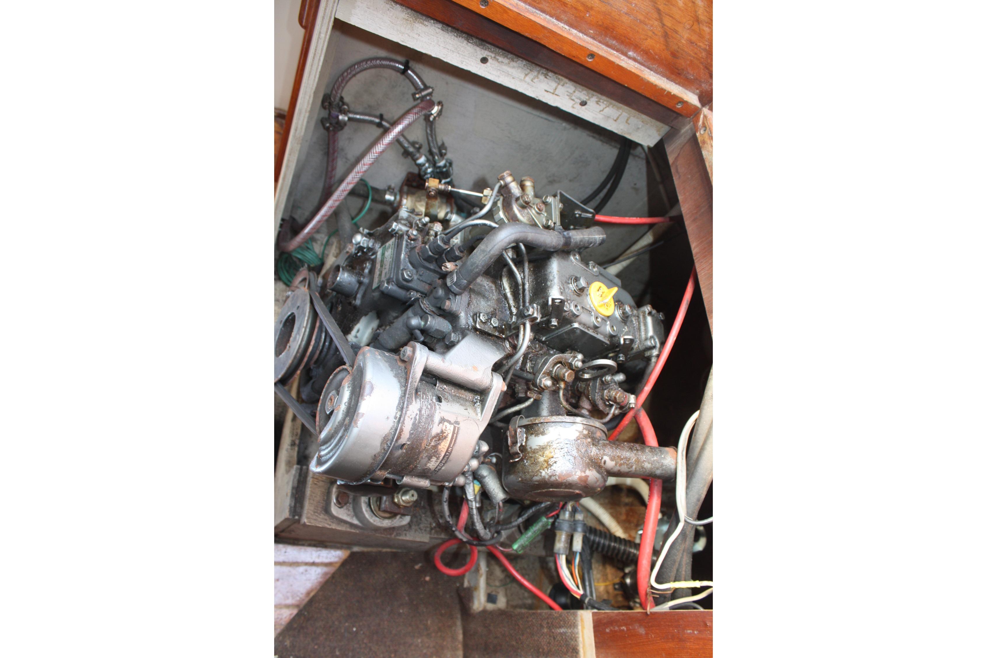 Engine compartment of a 1981 S2 9.2A sailboat, showing mechanical components and wiring.