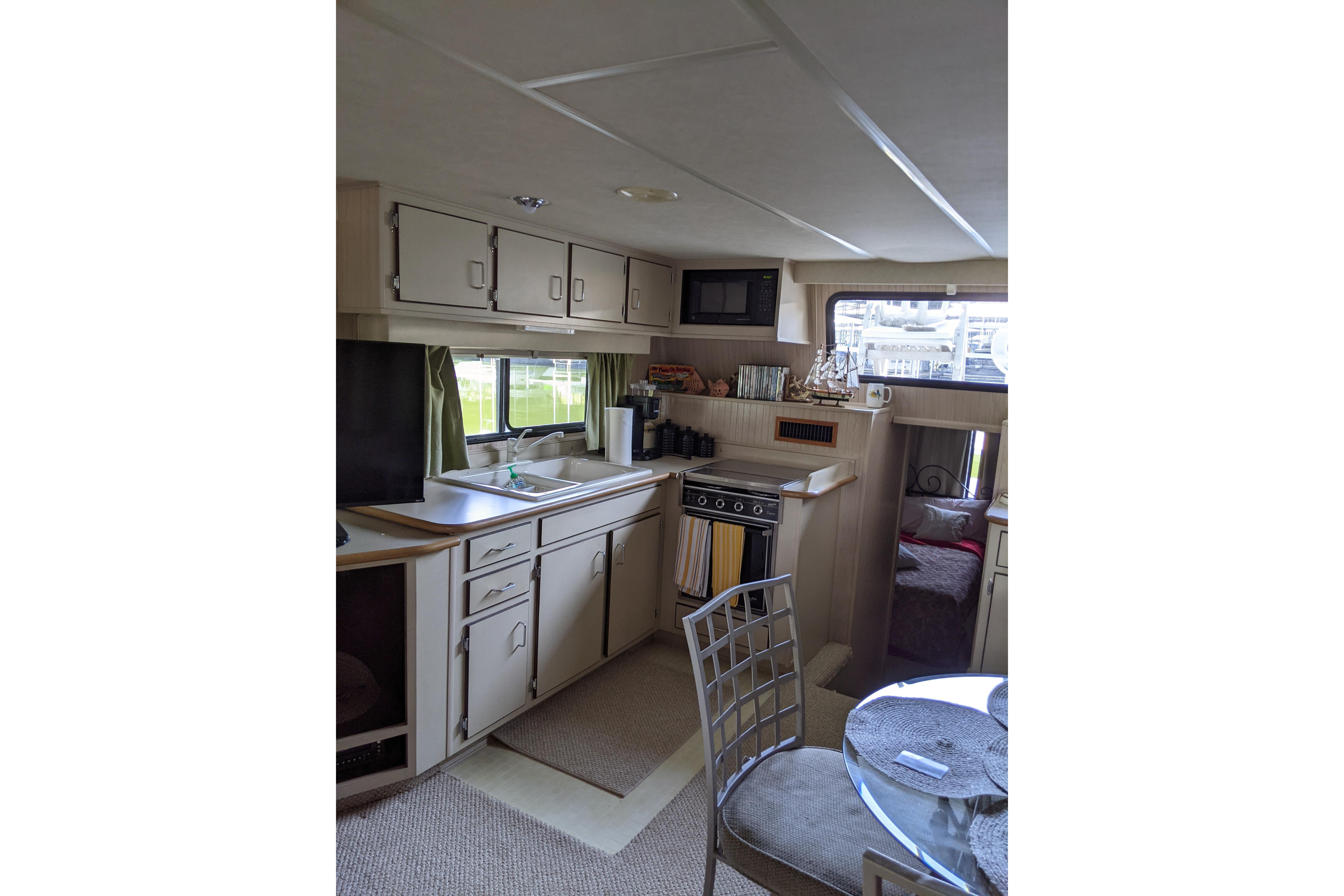 Interior of 2001 Gibson 50 Cabin Yacht featuring kitchen and dining area.
