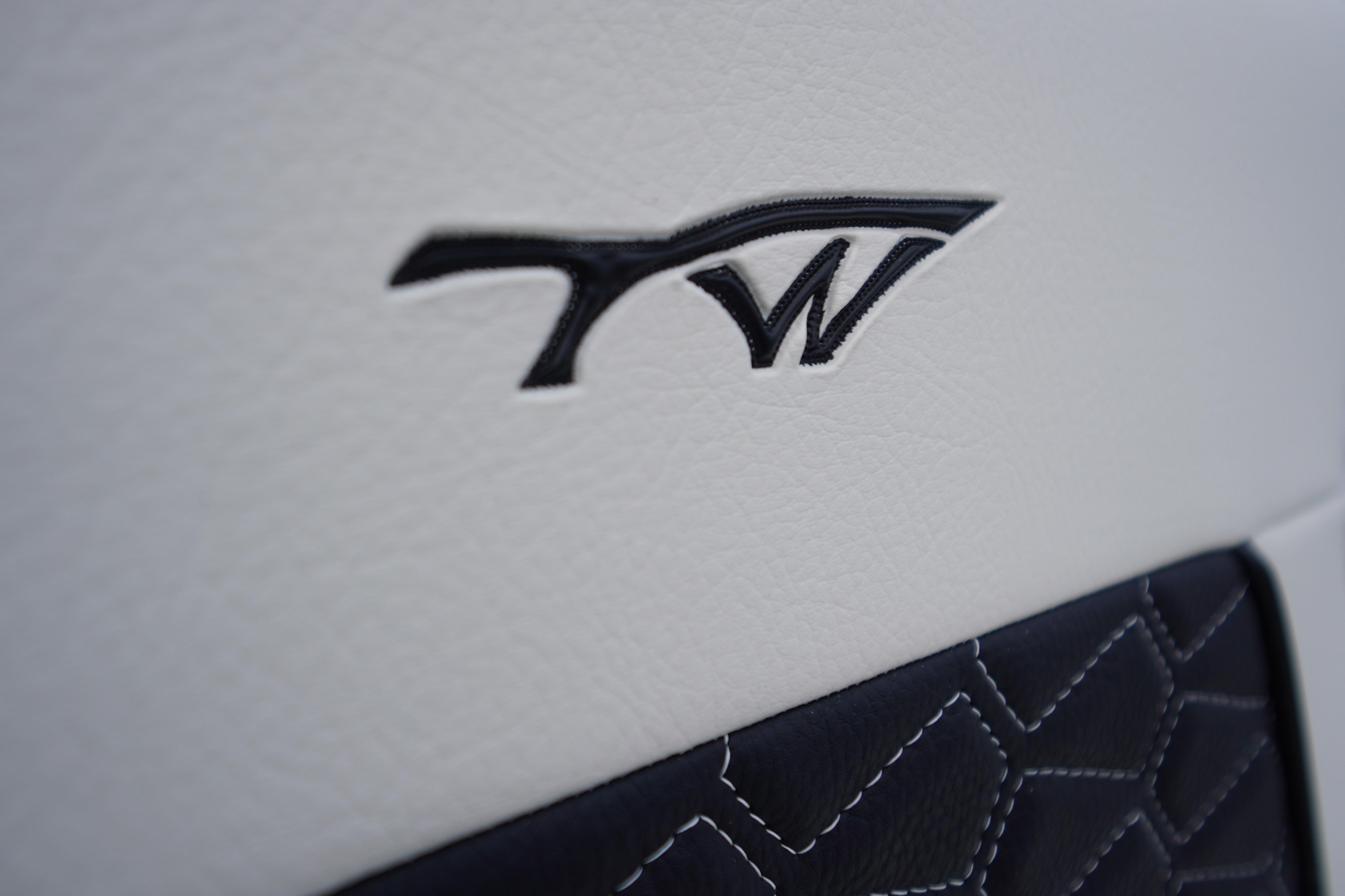 Close-up of Tidewater 232 SS 2026 logo on white leather upholstery.