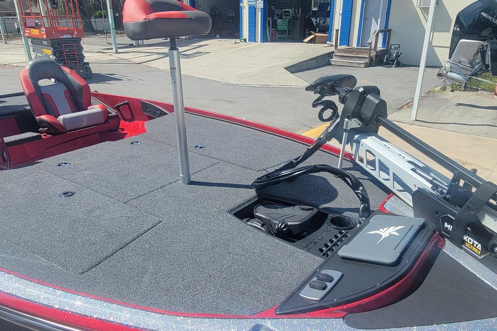 2026 Nitro Z18 boat deck with seating and trolling motor in a sunny outdoor setting.