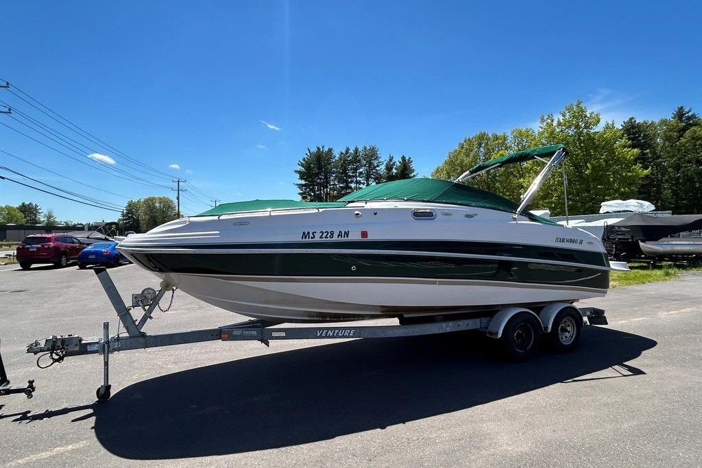 2006 Four Winns 244 Funship boat on trailer under clear blue sky.