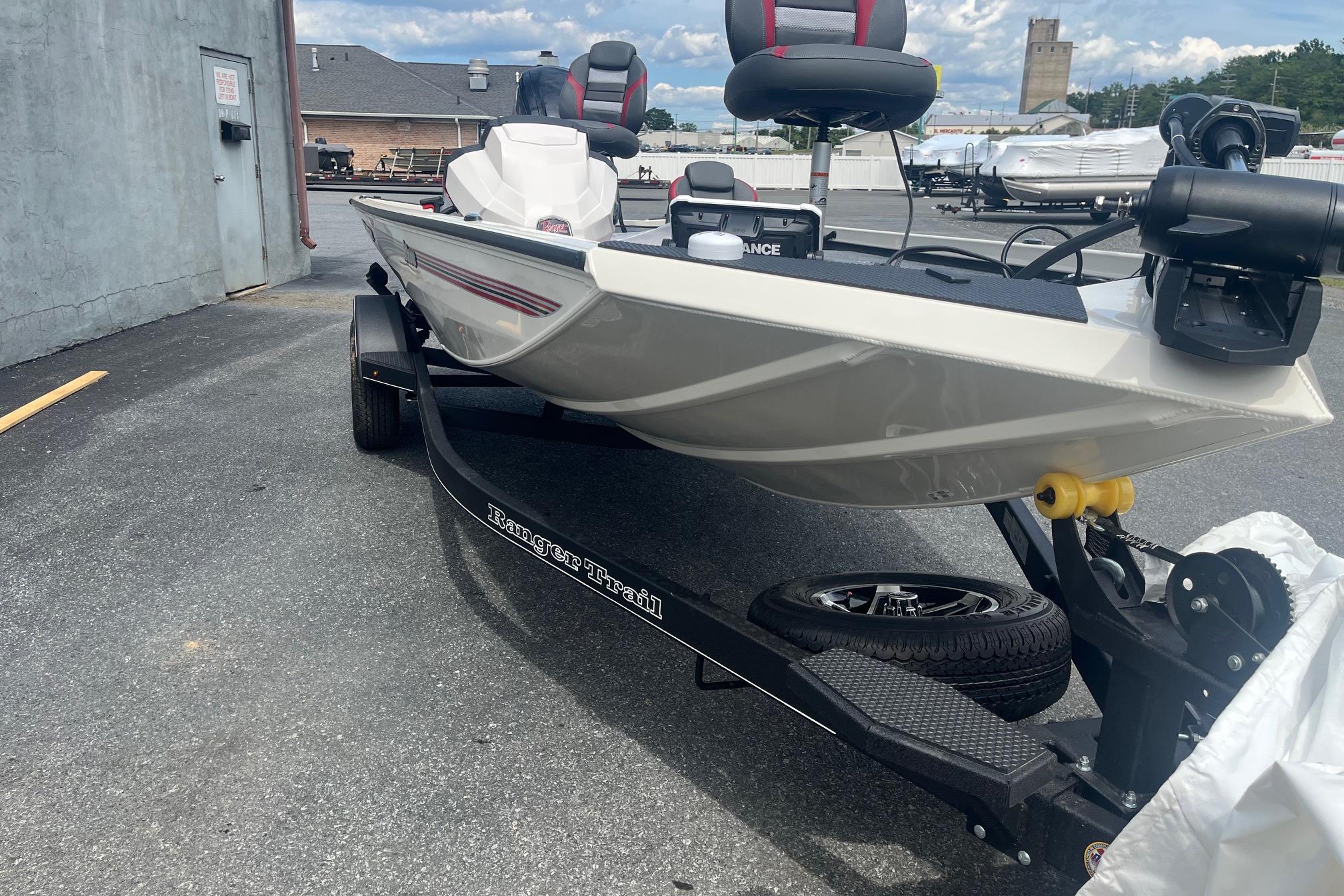 2025 Ranger RT178 boat on trailer, parked outdoors, showcasing sleek design and modern features.