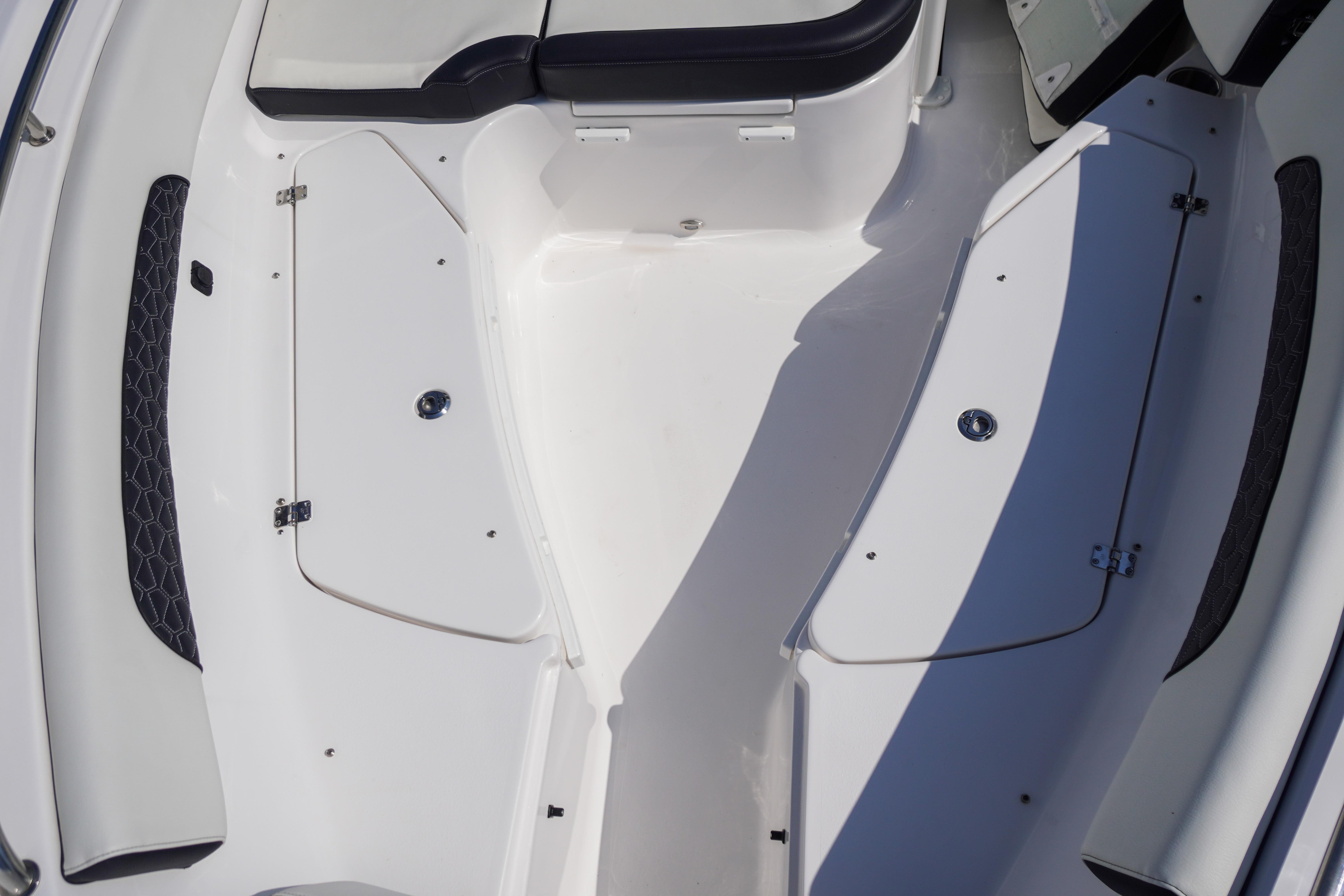 2025 Tidewater 232 SS boat interior with storage compartments and seating.