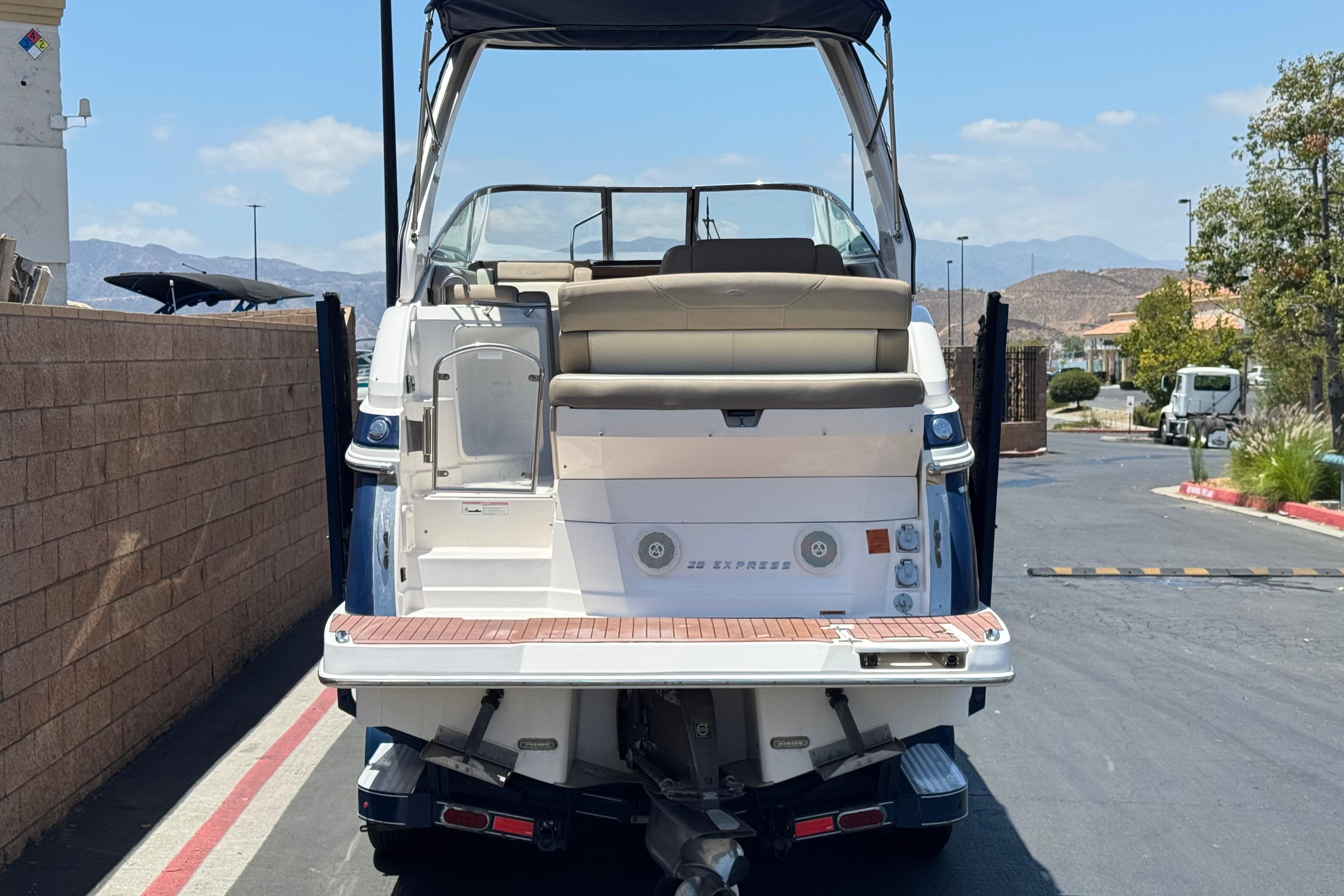 2013 Regal 28 Express boat, rear view, parked on a sunny day.