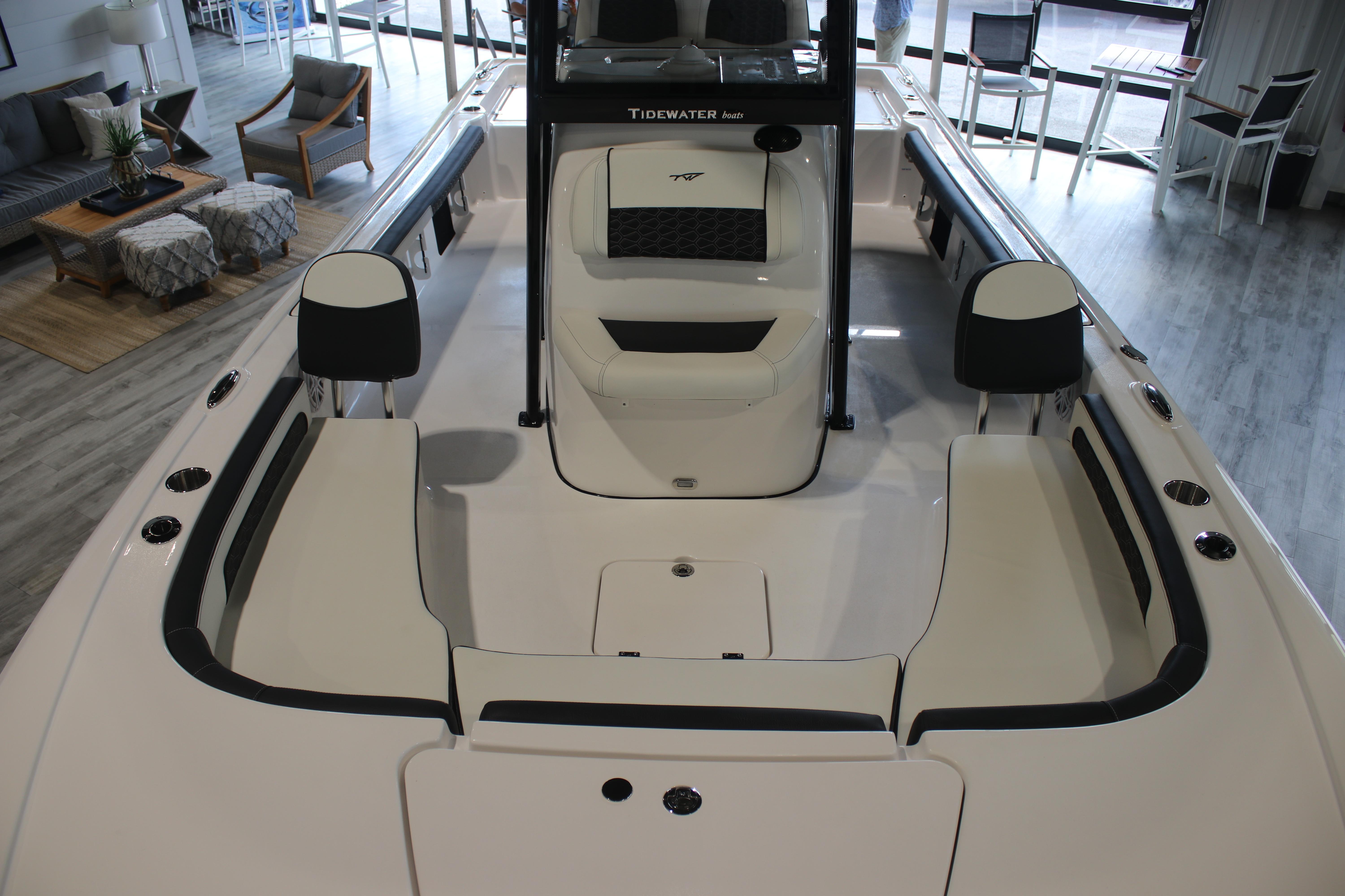 2026 Tidewater 2300 Carolina Bay boat interior with seating and console in showroom.