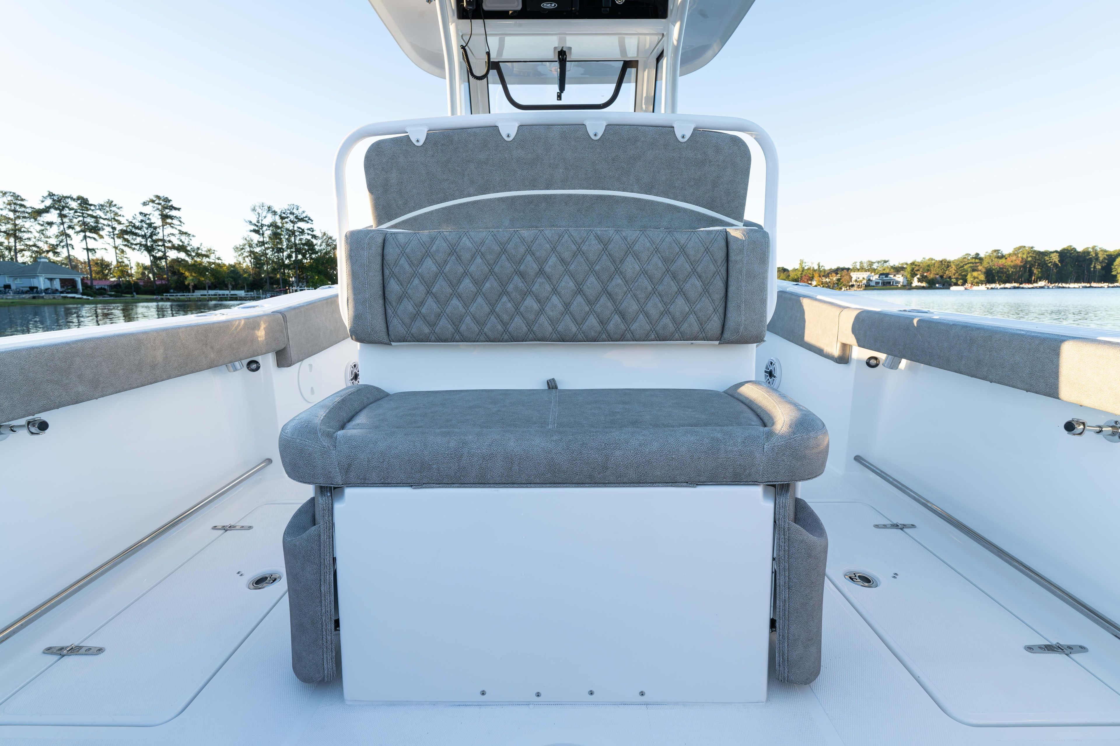 2026 Sea Hunt Ultra 275 Coffin Box boat interior with cushioned seating and scenic water view.