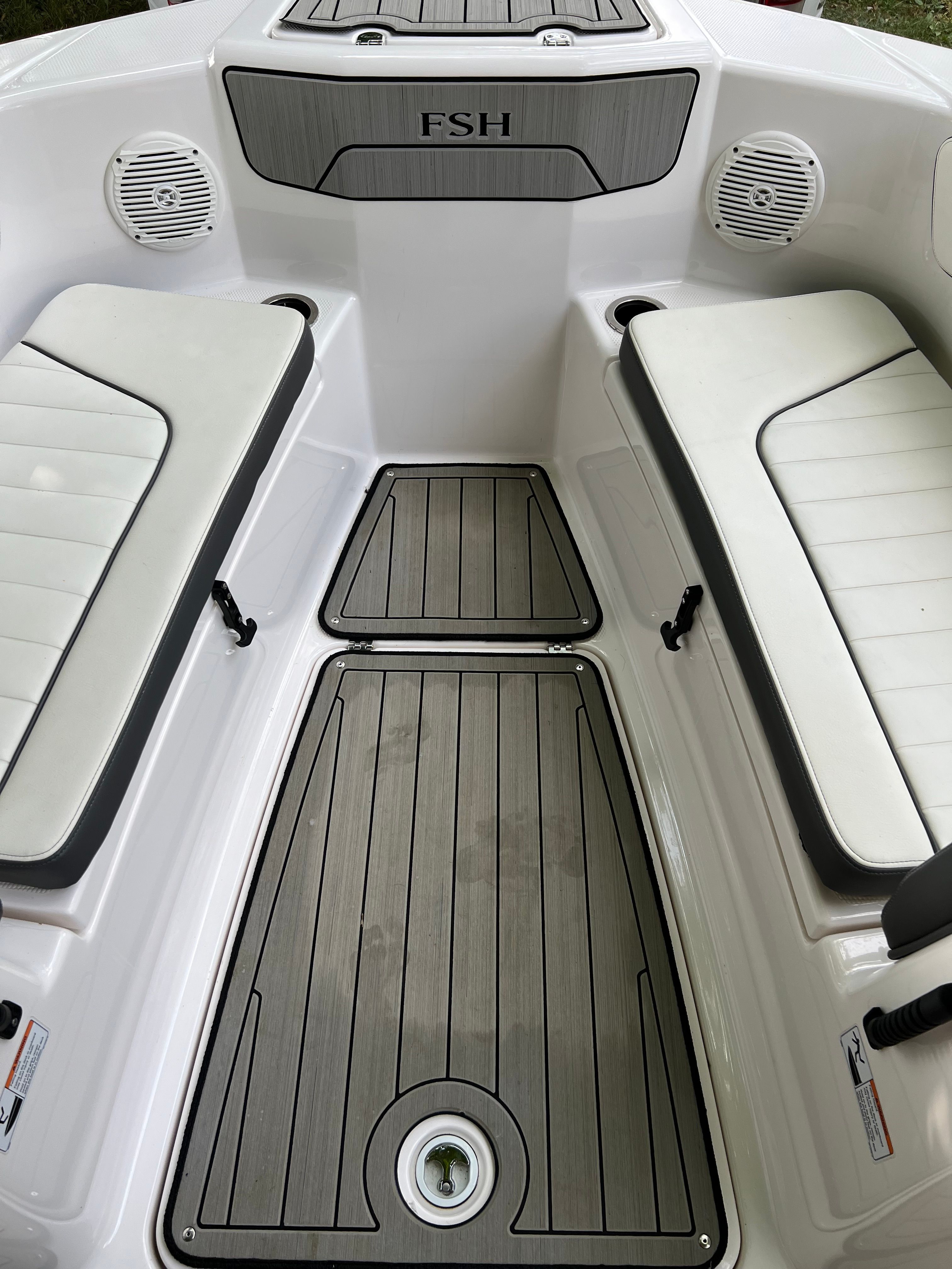 Interior of a 2022 Yamaha 210 FSH Deluxe boat with seating benches.