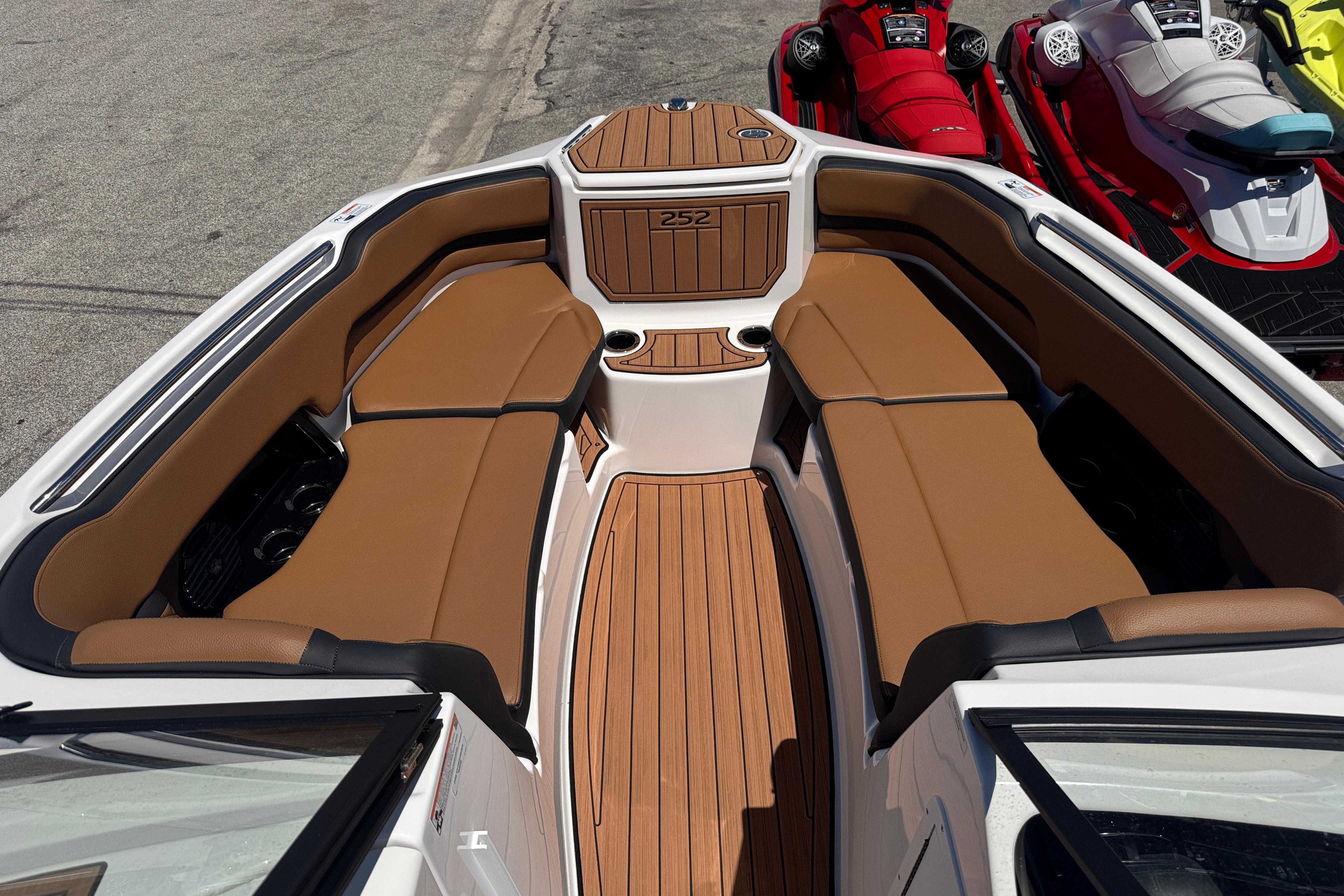 2026 Yamaha Boats 252SD interior with tan seating and wood-style flooring.