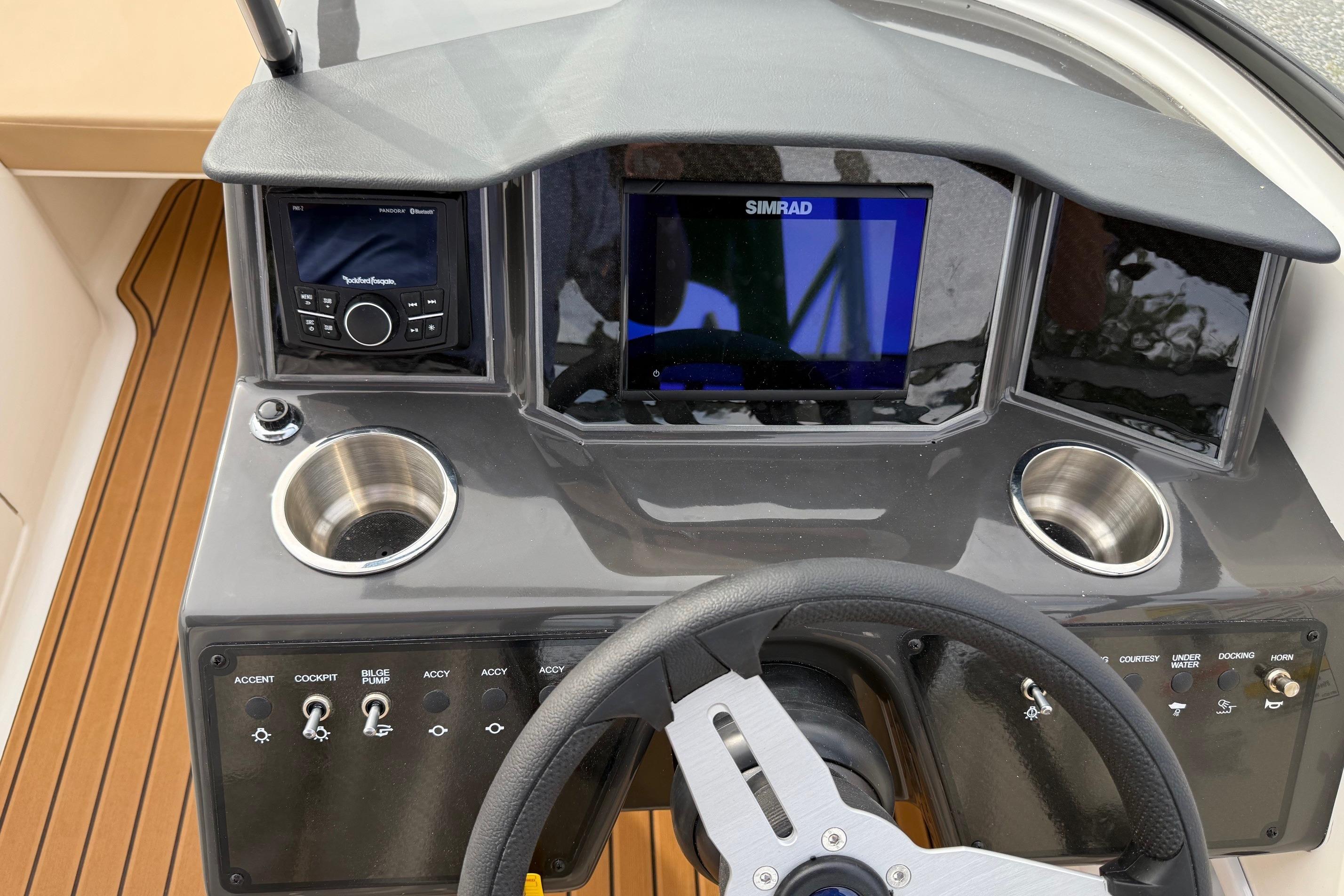 2026 Bayliner VR6 Bowrider OB dashboard with Simrad display and control panel.