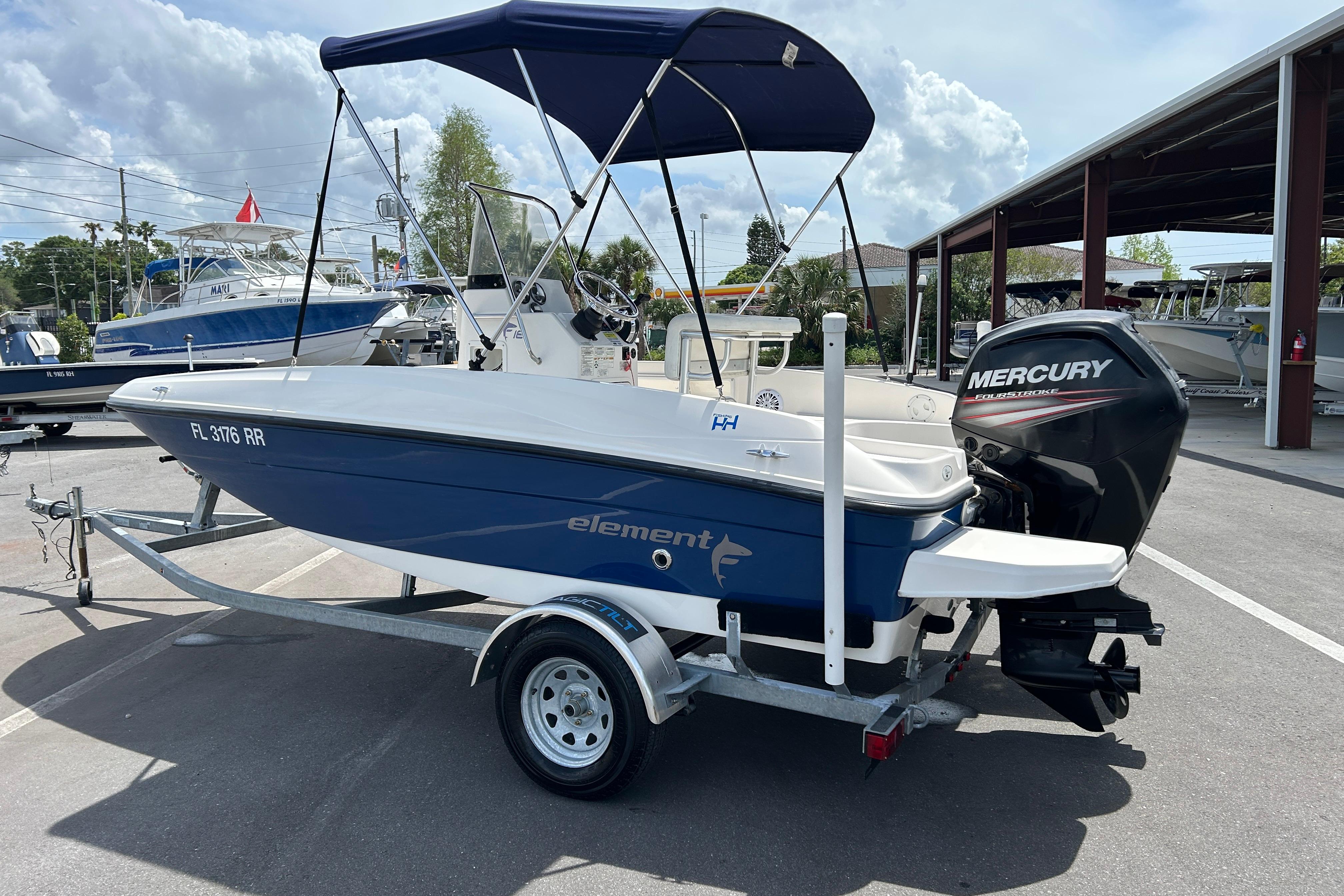 2018 Bayliner Element F16 boat with Mercury engine on trailer, parked outdoors.