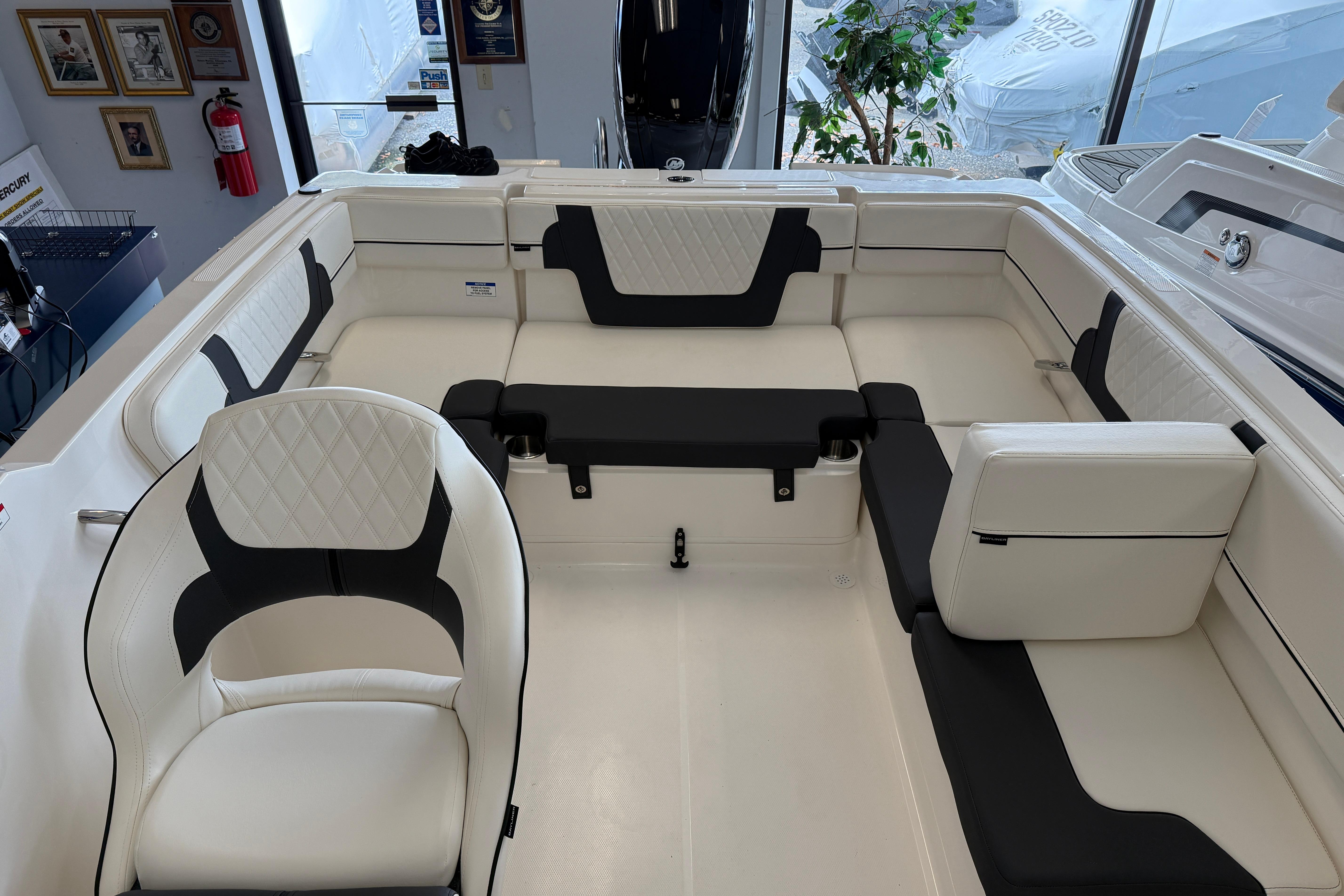 2025 Bayliner VR4 Bowrider OB interior with white and black seating, showroom display.