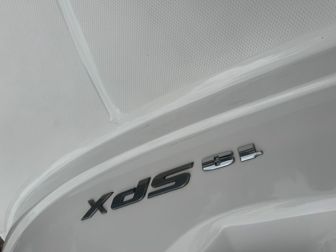 Close-up of the Sea Ray SPX 190 Outboard logo on a white boat hull.