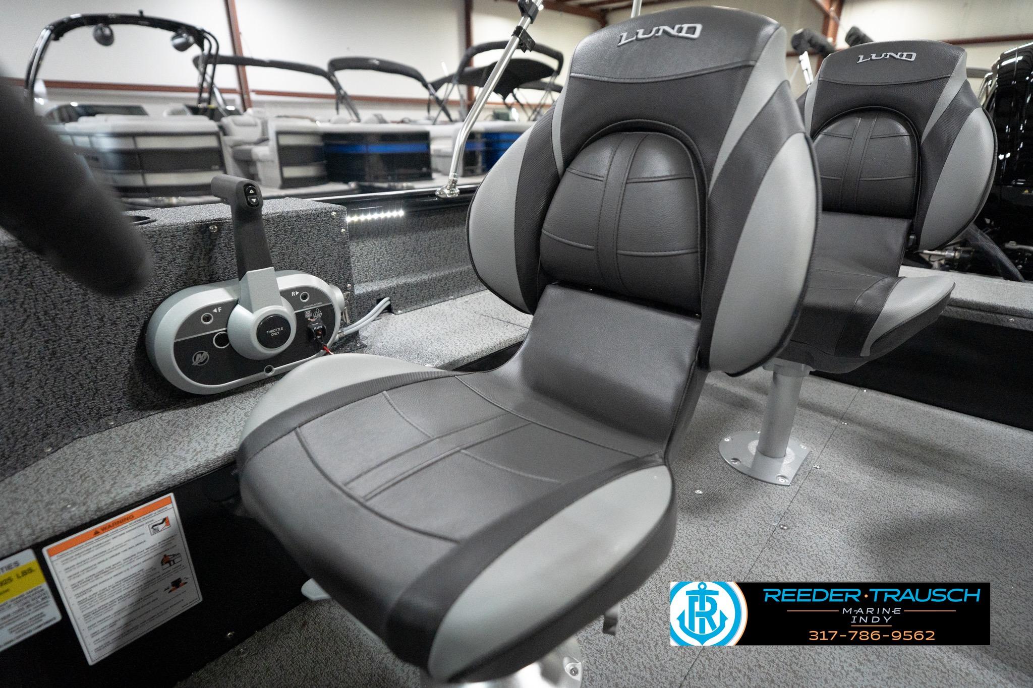 2026 Lund 1800 Explorer Sport boat interior with comfortable seating and control panel.