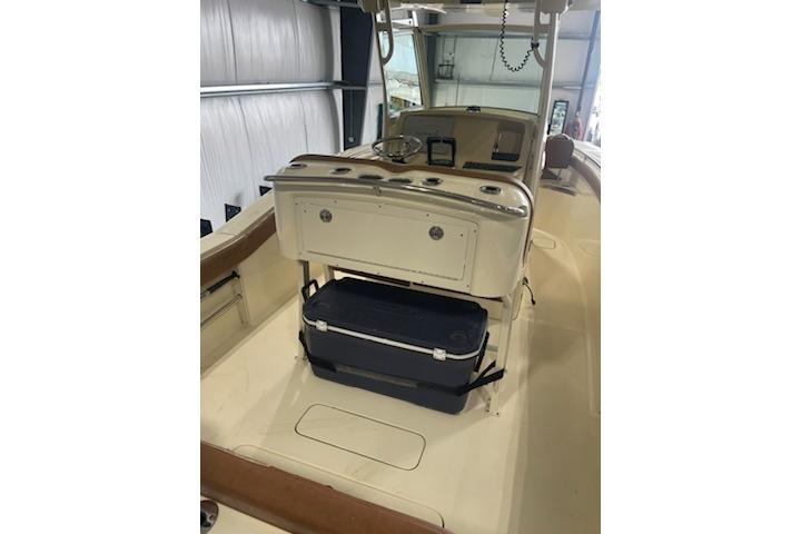 2015 Scout 255 LXF boat interior with console and cooler in storage area.