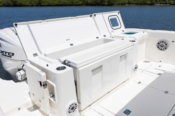 2025 Pursuit OS 405 boat deck with storage and engine, on calm water.